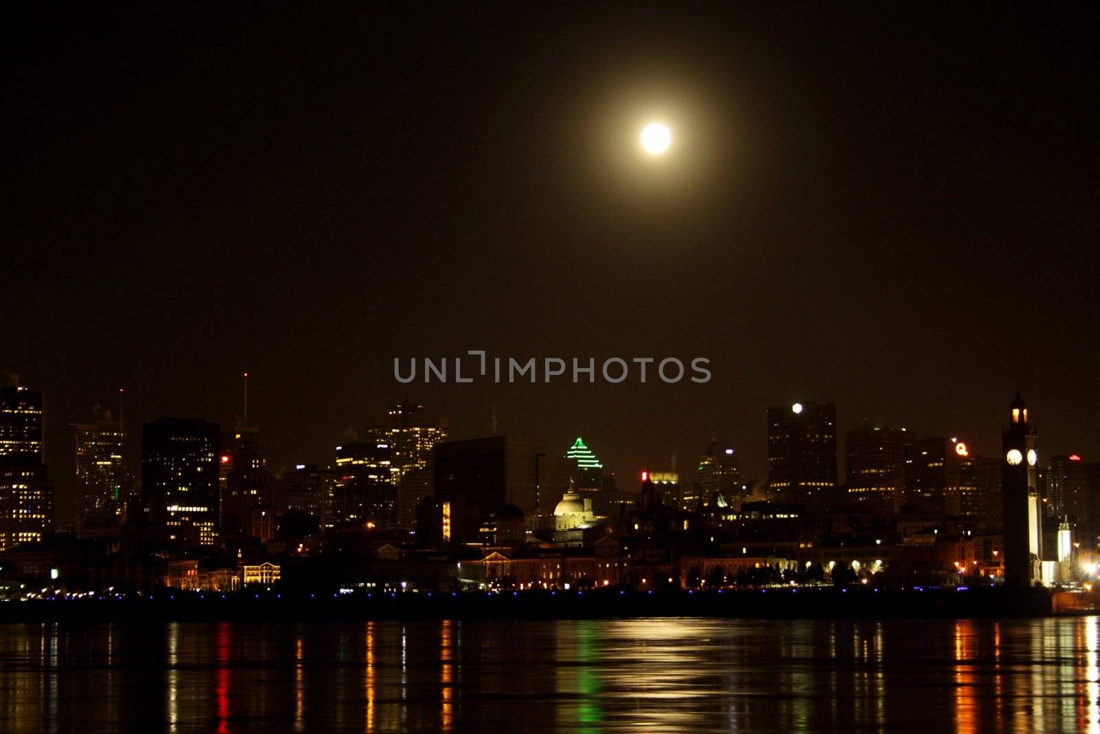 Water edge of Montreal skyline early winter morning with a full moon