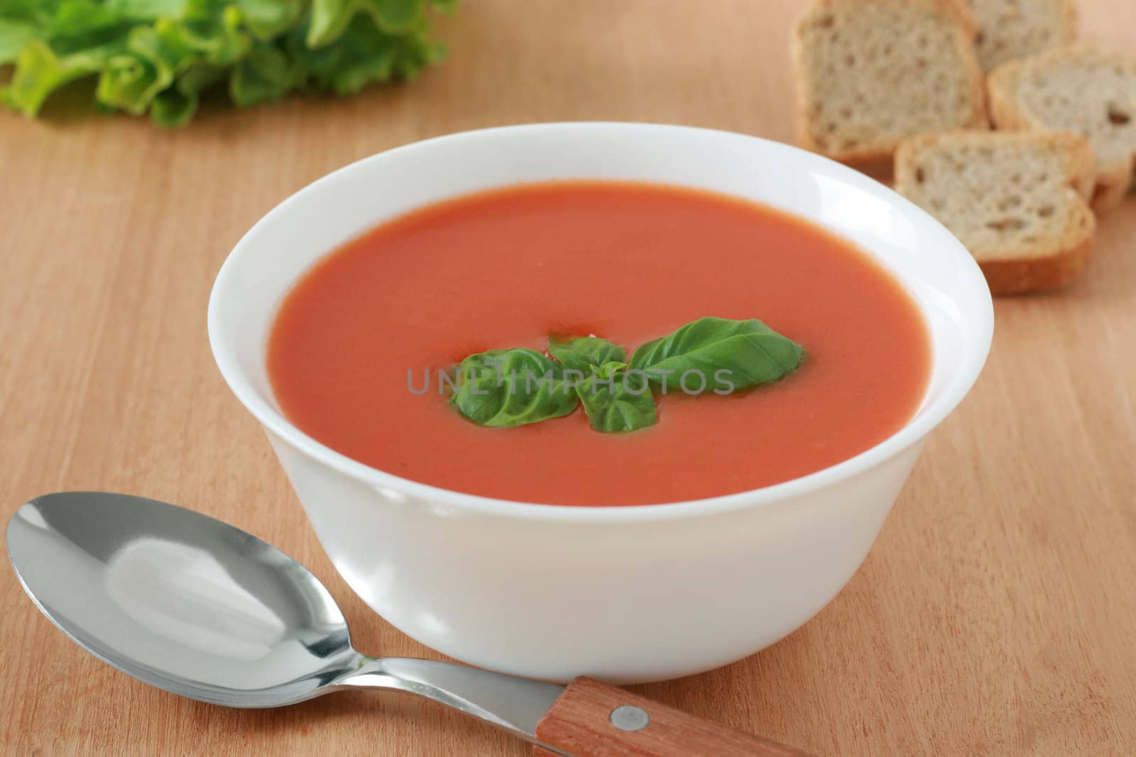 tomato soup with basil on bowl