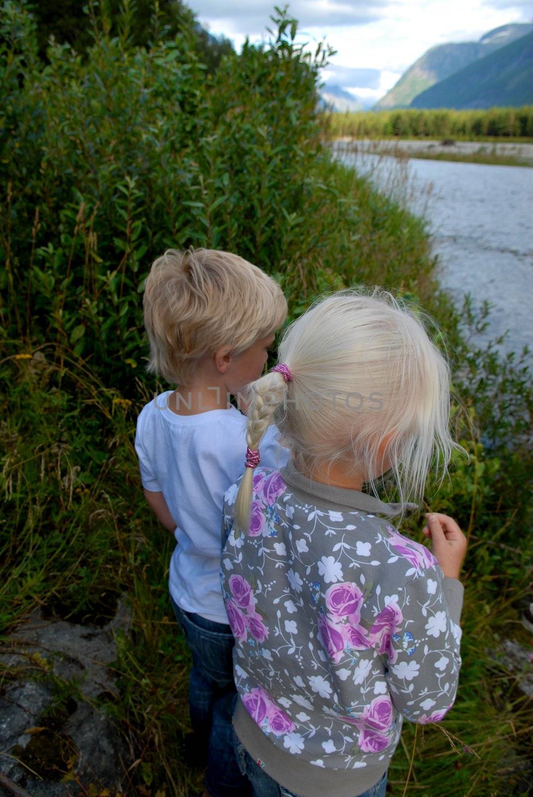 Scandinavian Lifestyle - children playing by the river by Bildehagen
