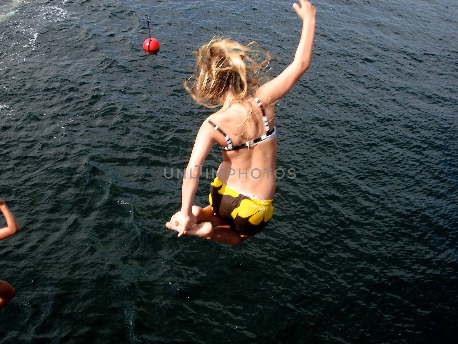 children diving into the sea. Please note: No negative use allowed.