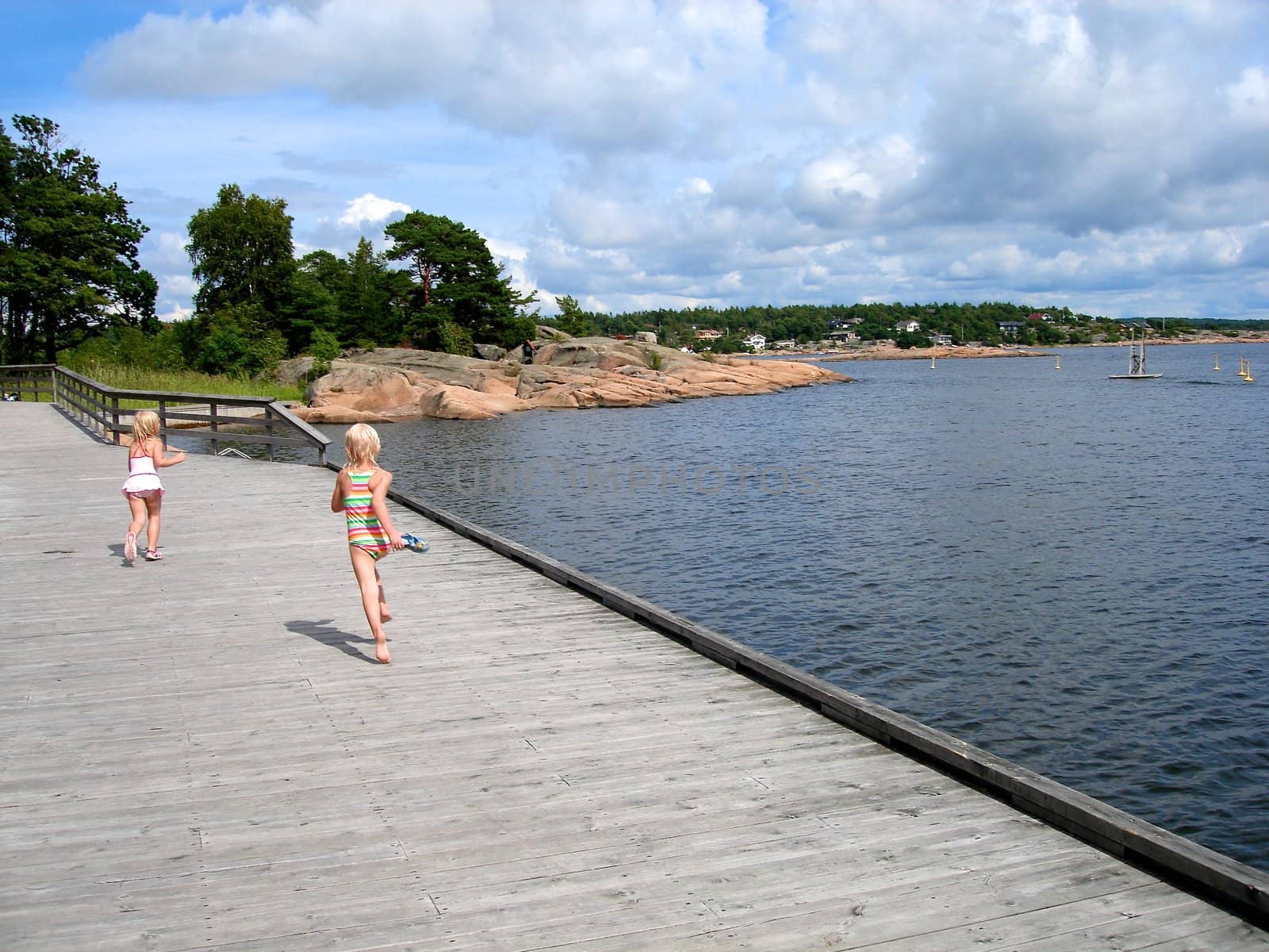 girls playing at the seaside. Please note: No negative use allowed.