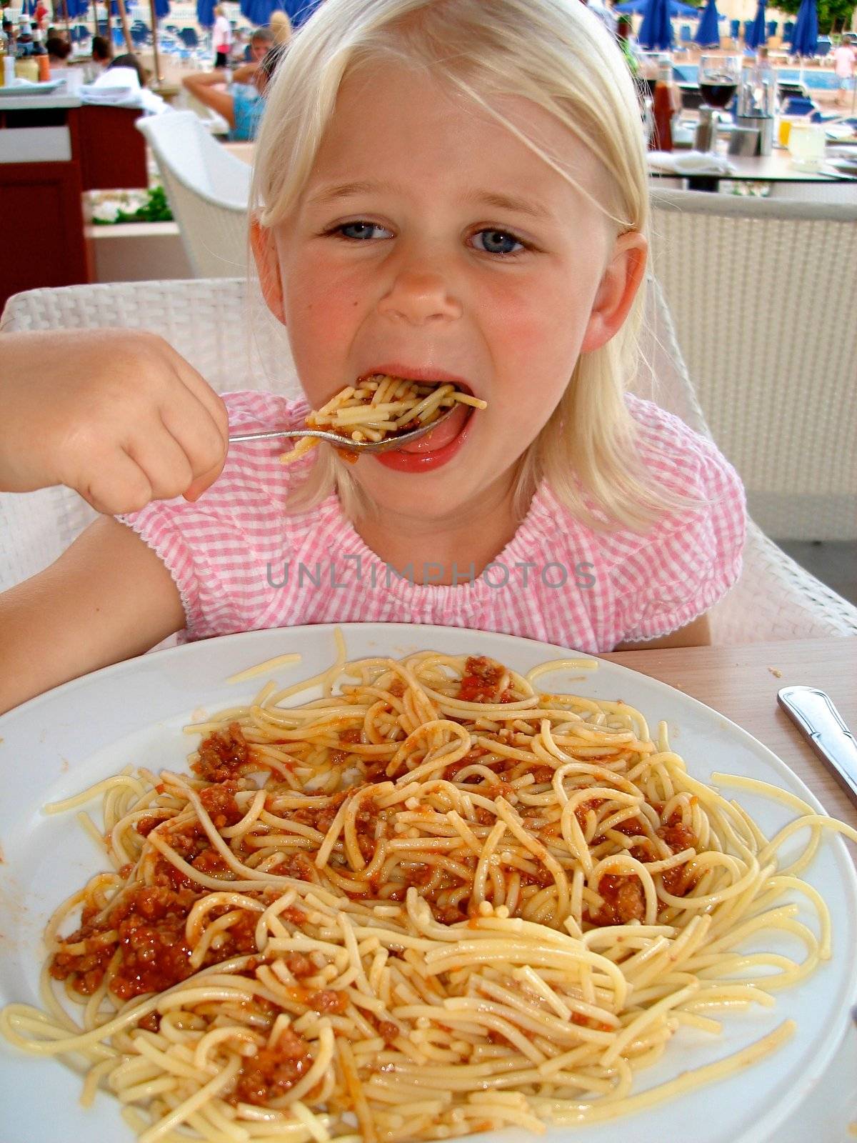 little girl eating noodles. Please note: No negative use allowed.