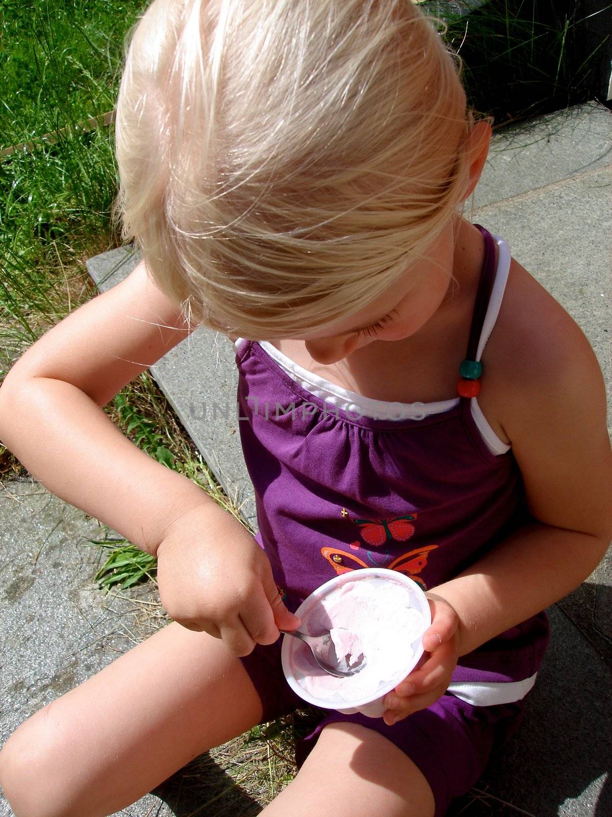 little girl eating ice cream. Please note: No negative use allowed.
