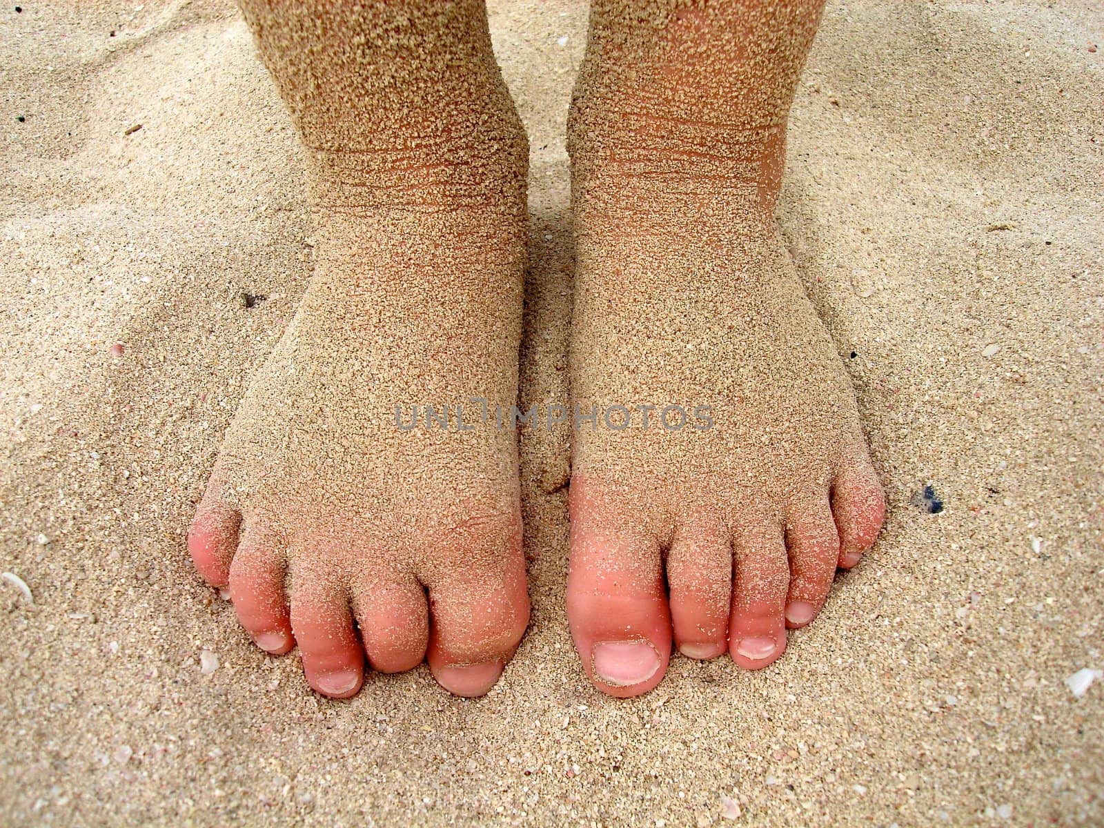 child's feet on the beach. Please note: No negative use allowed.