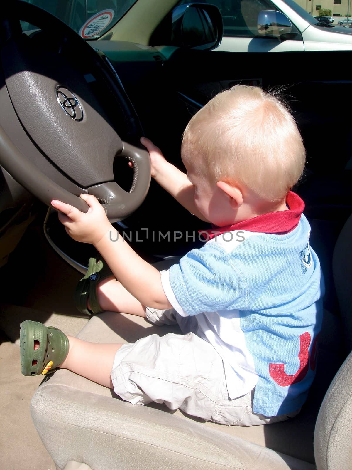 Scandinavian Lifestyle - little baby driving the car by Bildehagen