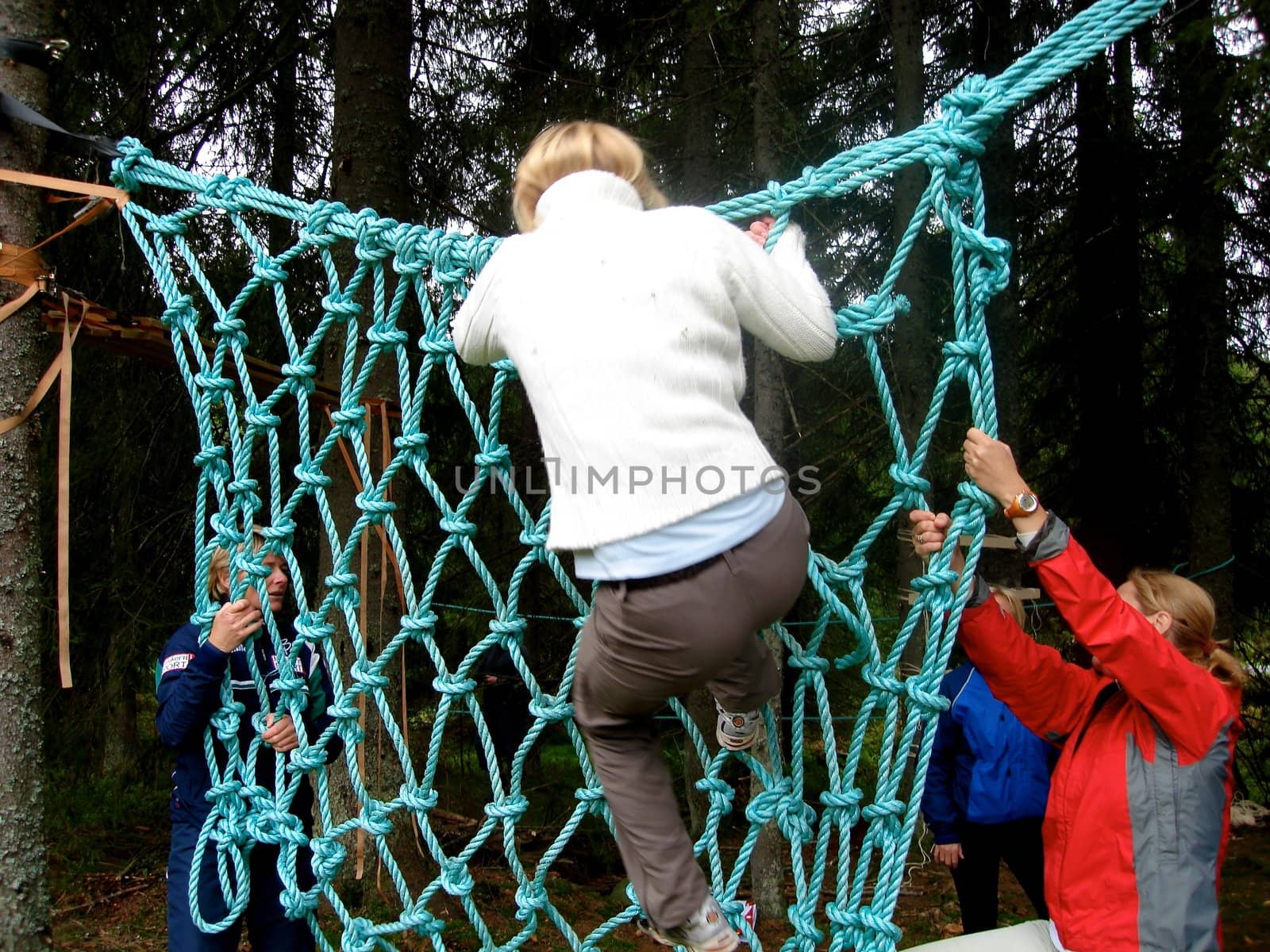 boy climbing the net