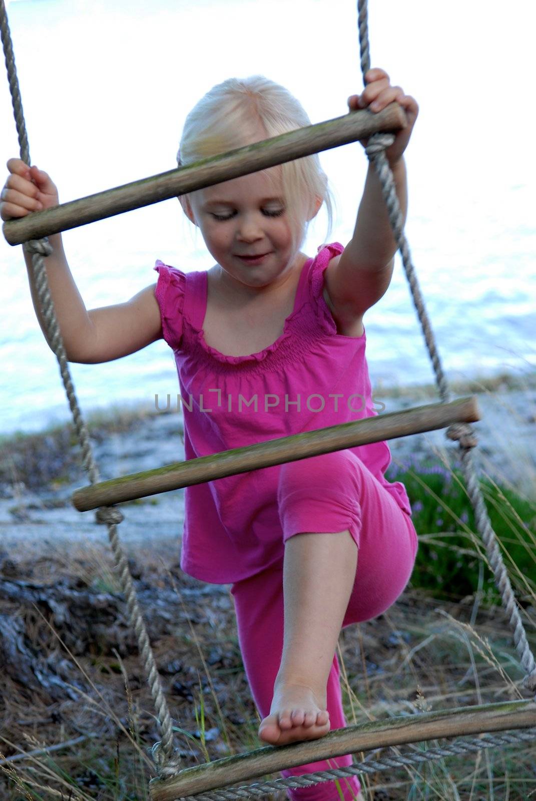 Scandinavian Lifestyle - little girl climbing the ladder by Bildehagen