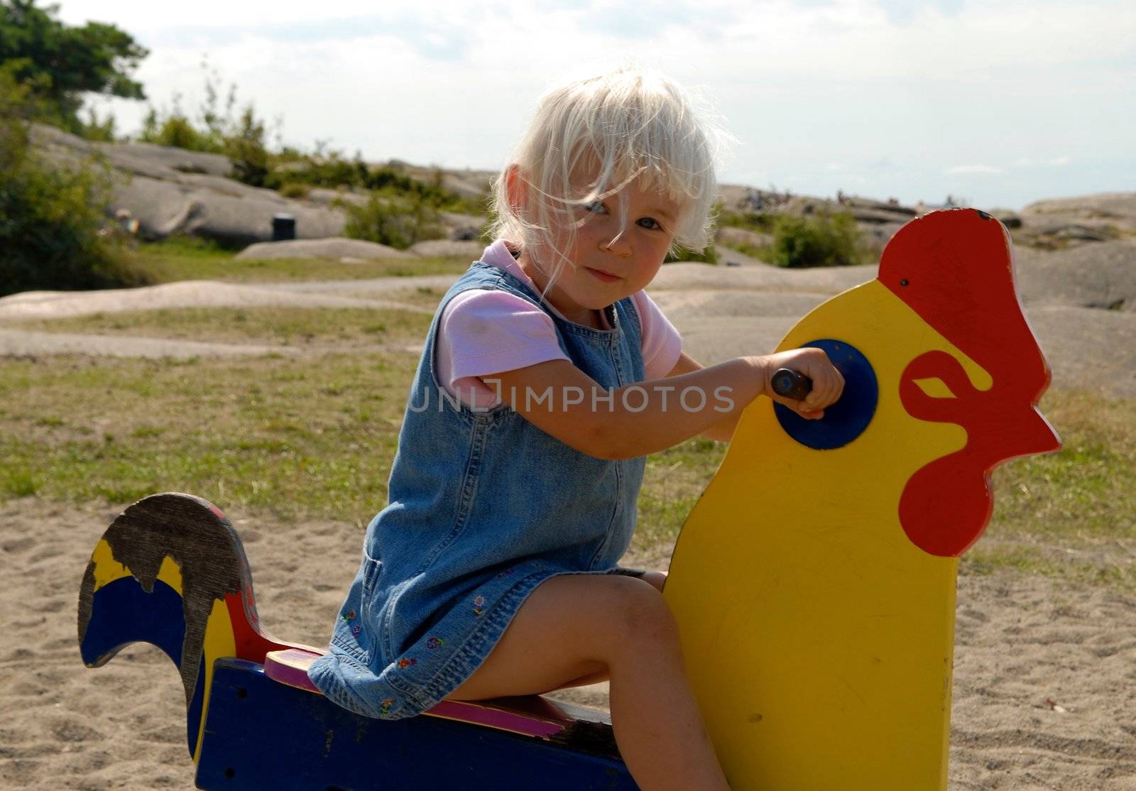 Scandinavian Lifestyle - girl playing on the toy cock by Bildehagen