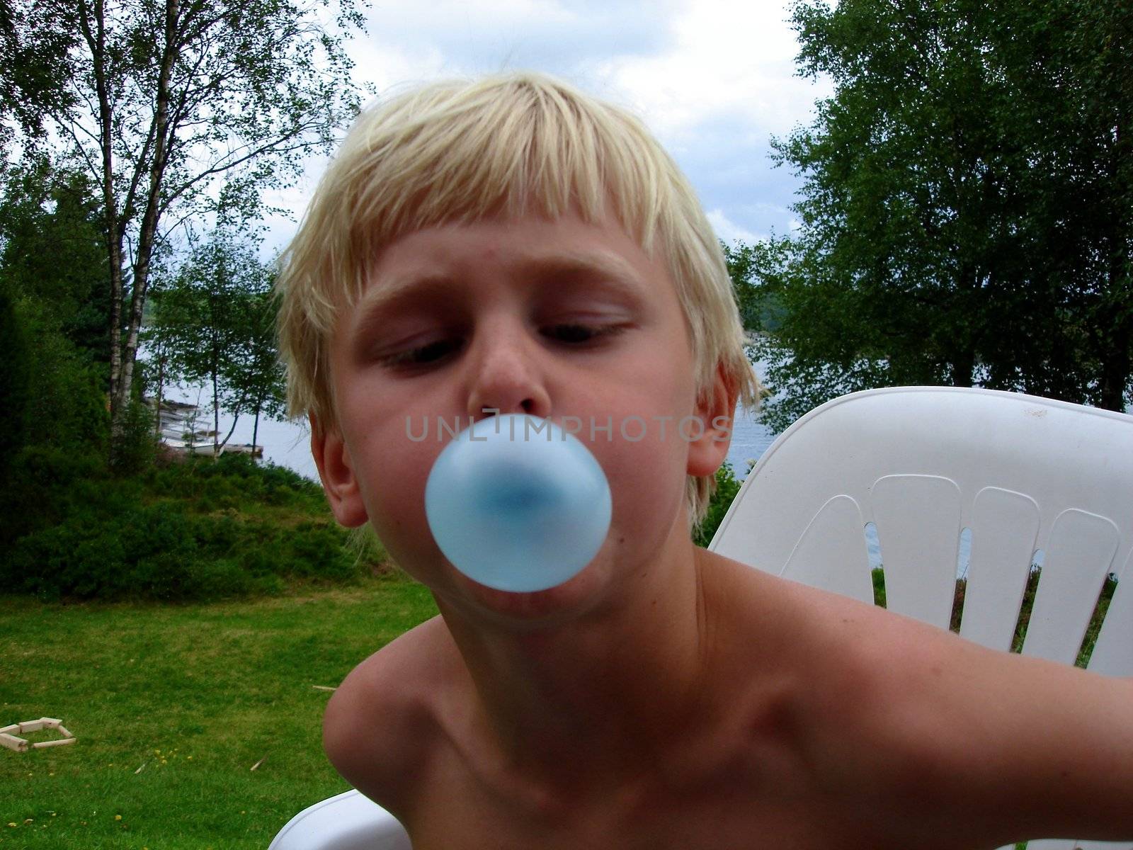 boy blowing a bubble. Please note: No negative use allowed.