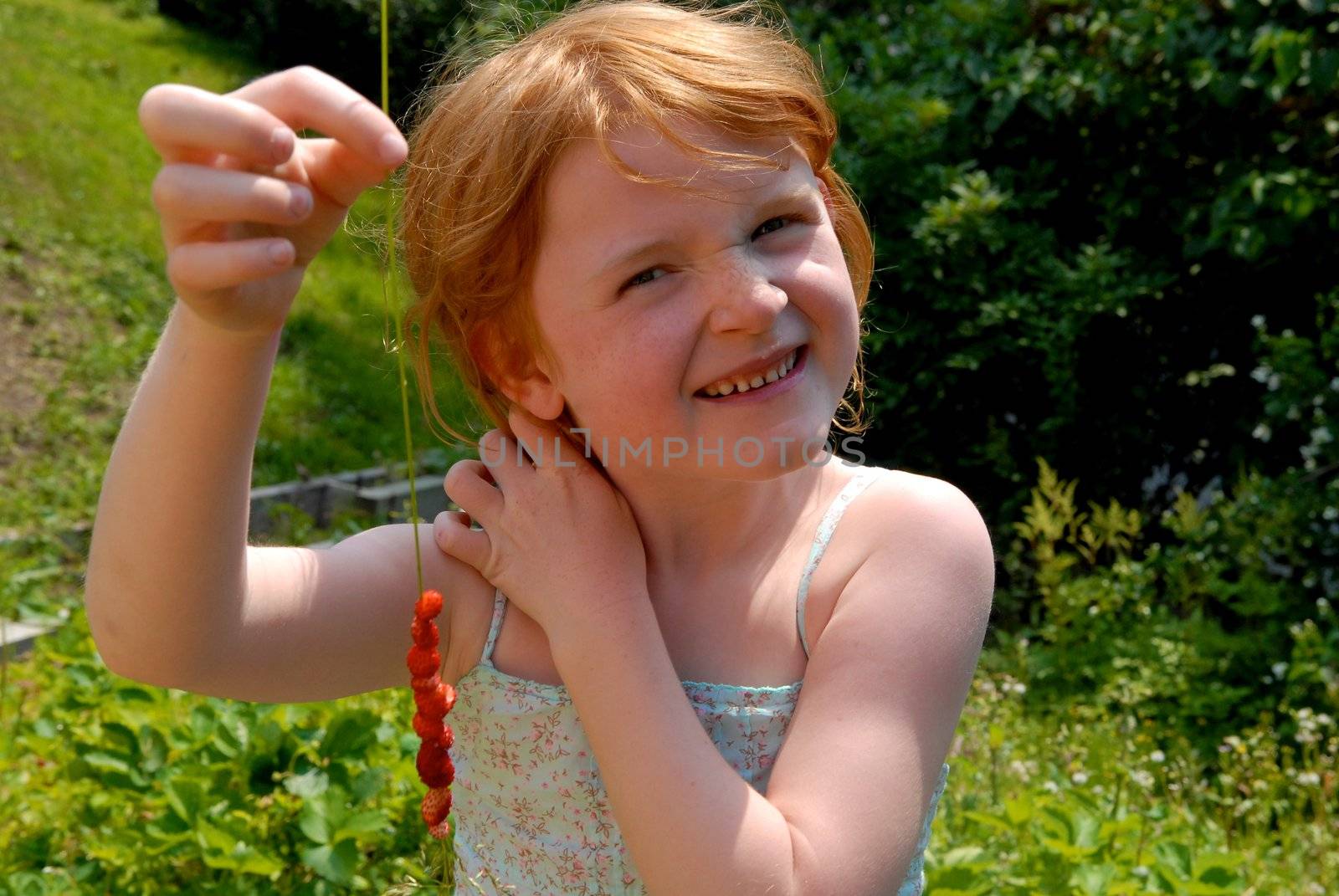 girl making the strawberry string. Please note: No negative use allowed.