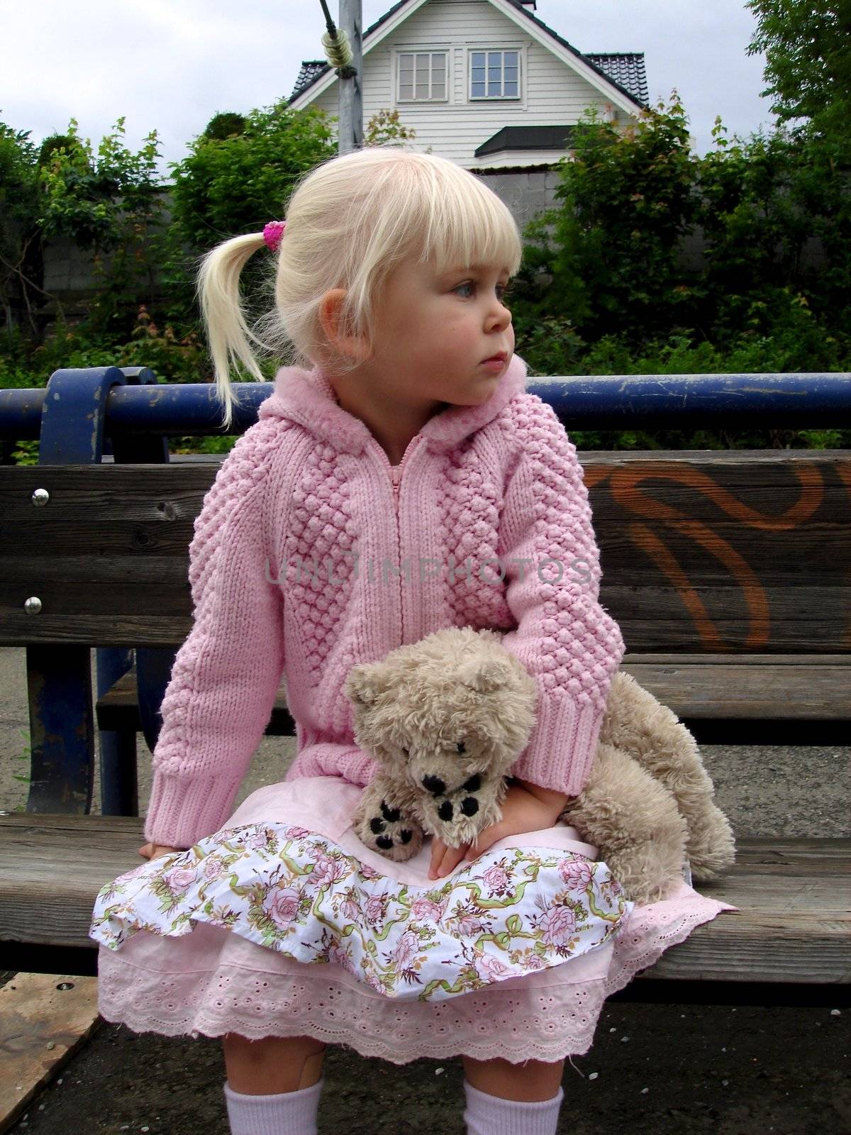 Scandinavian Lifestyle -  girl sitting with toy bear by Bildehagen