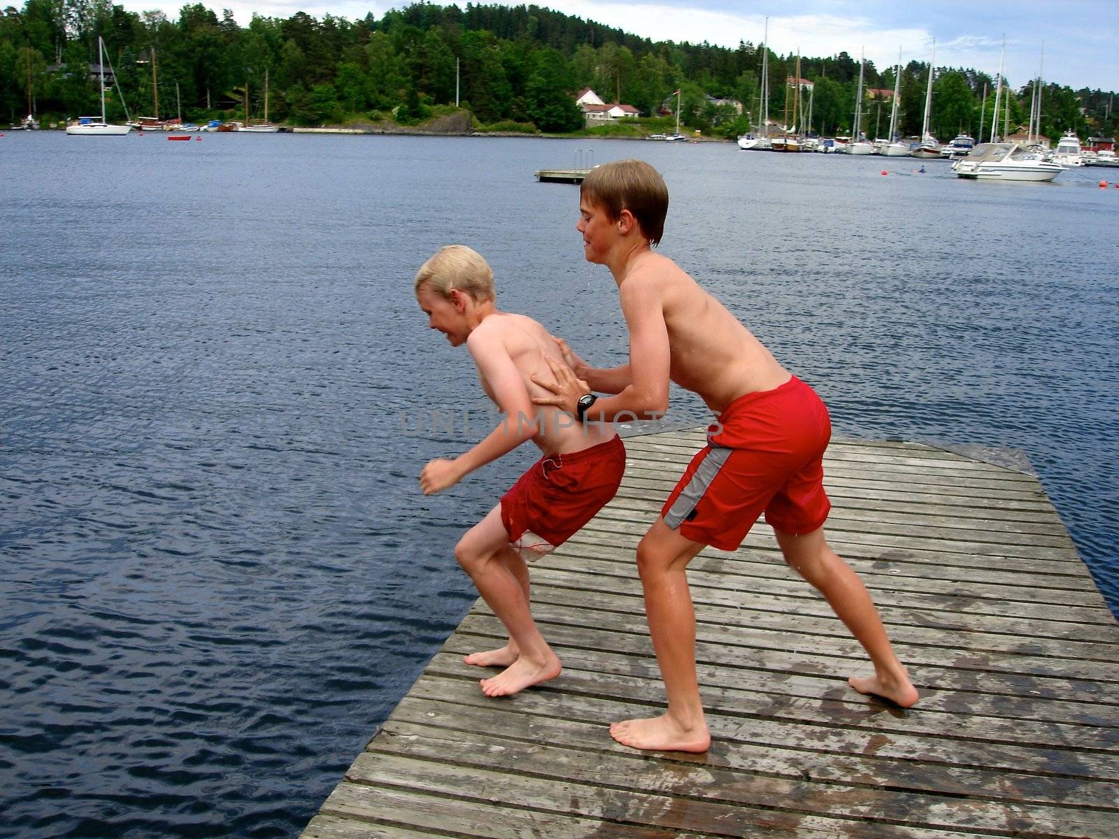 Scandinavian Lifestyle - boys jump into the sea by Bildehagen
