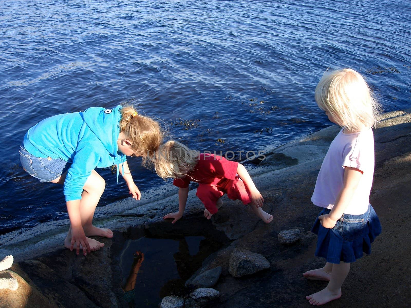 girls playing at the seaside. Please note: No negative use allowed.