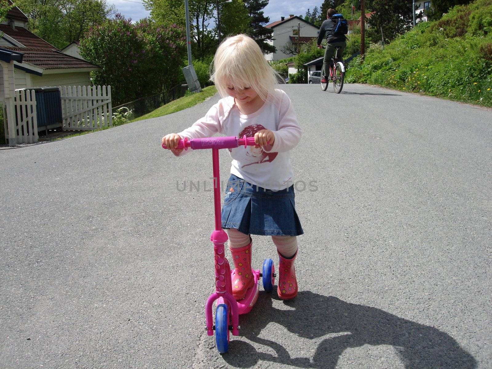 girl playing the scooter. Please note: No negative use allowed.