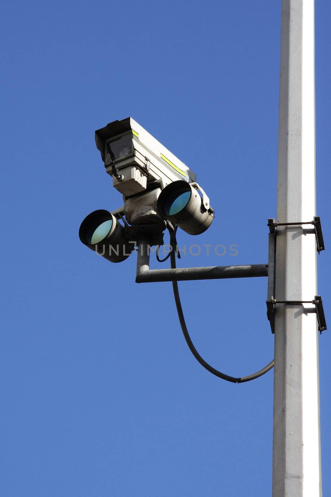 Traffic camera against blue sky
