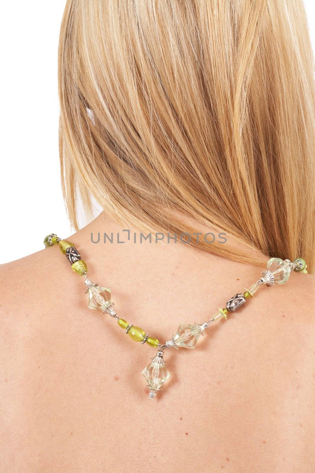 Beautiful blonde woman with long hair wearing green necklace isolated on white background