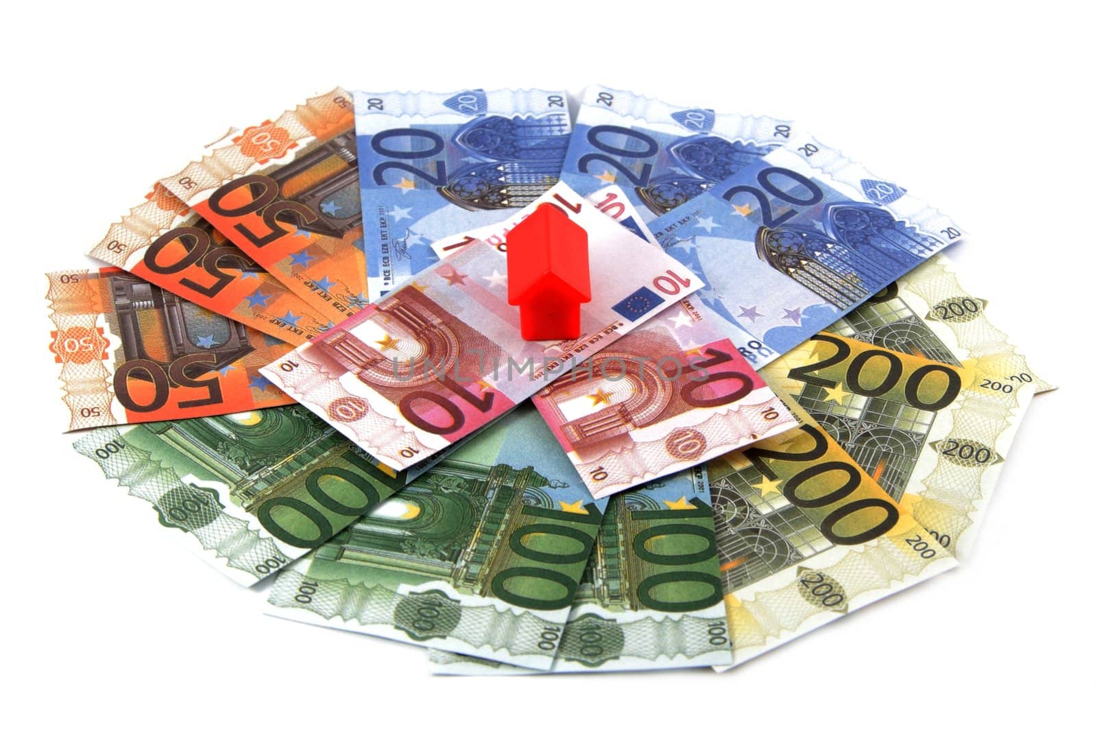 Plastic toy houses on money, isolated on white
