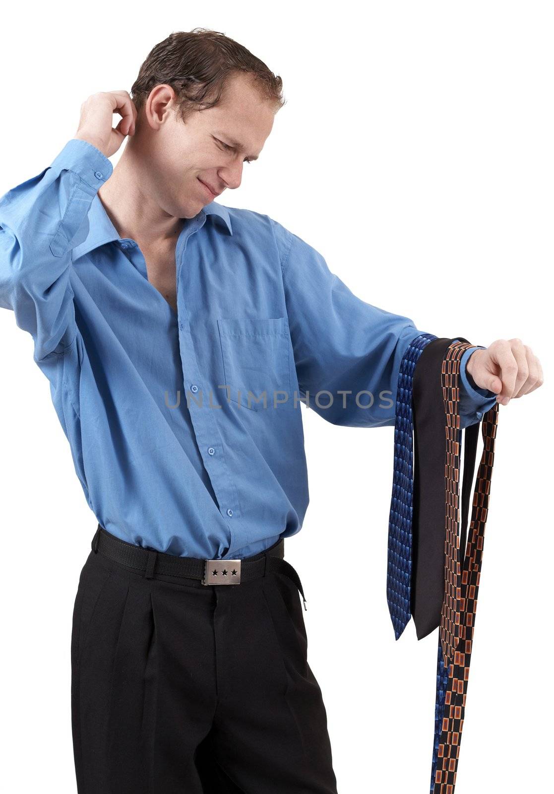 Young successful businessman wearing an office clothes having a problem choosing a tie. Isolated on white background