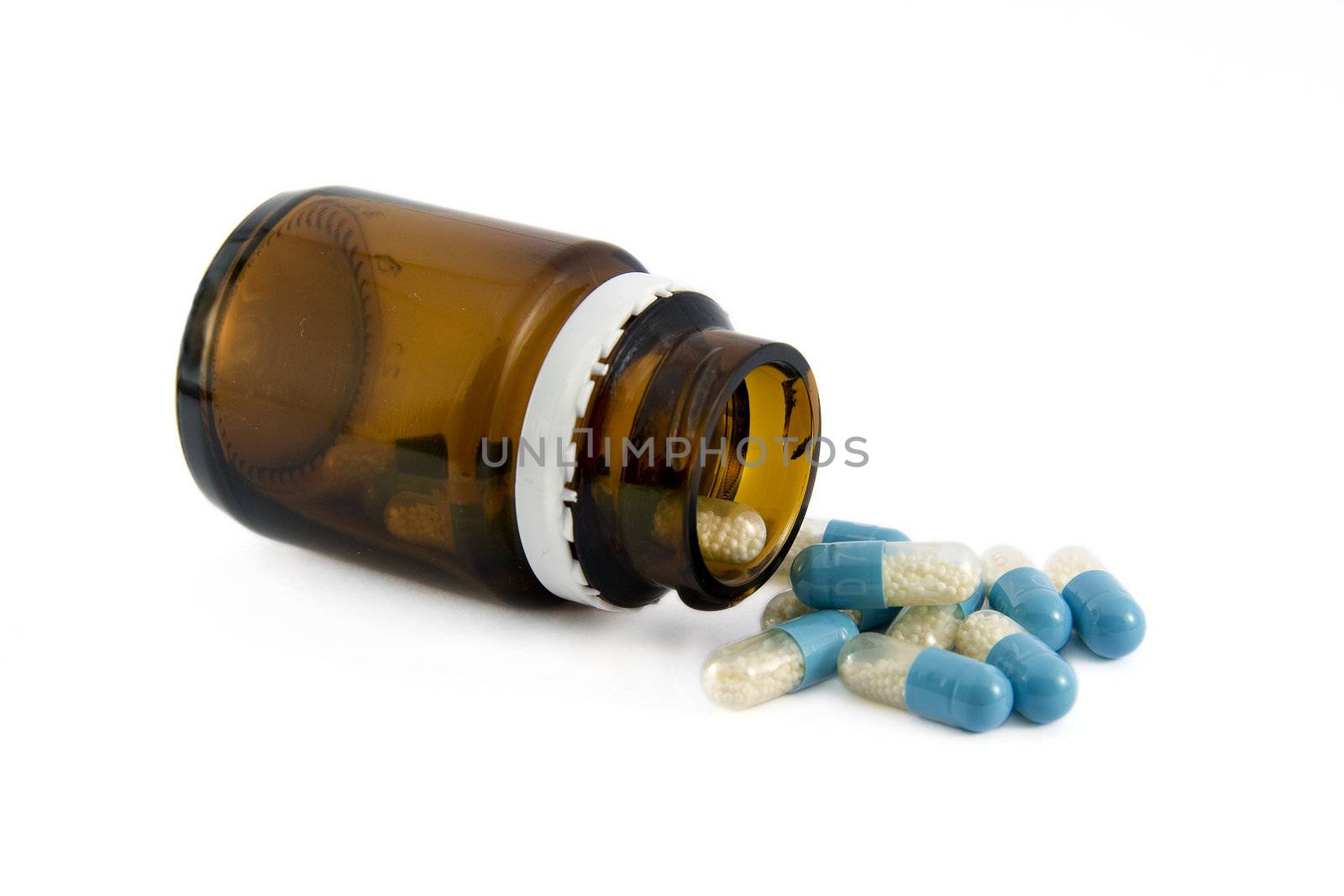 Pills from bottle on the white 