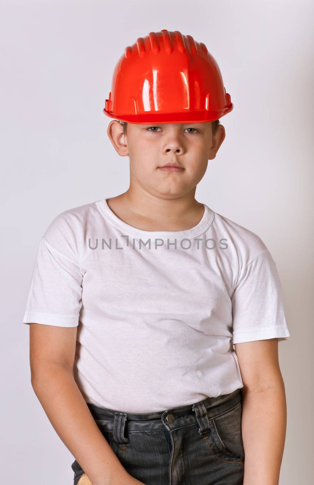 Portrait of a boy in a red protective helmet