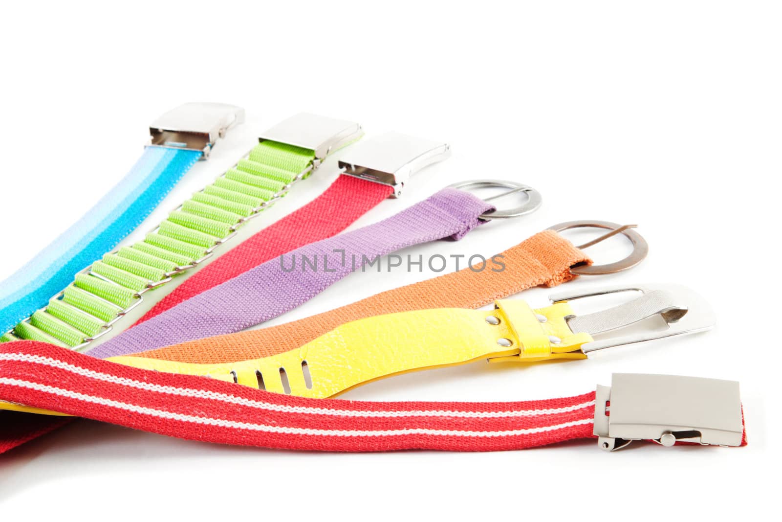 7 rainbow colored textile belts isolated over white background