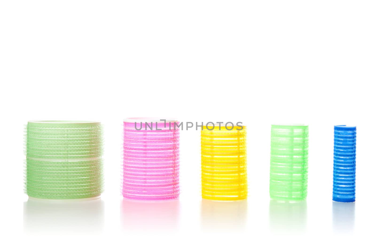 Multicolored hair curlers isolated over white background