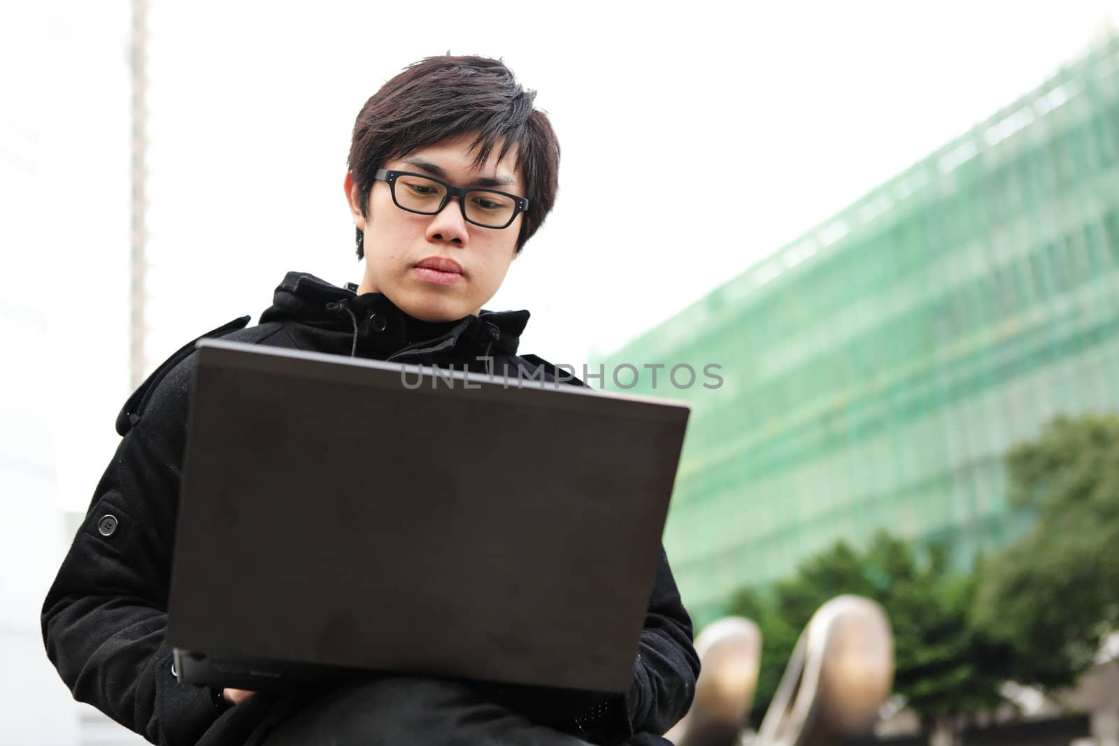 man using computer outdoor