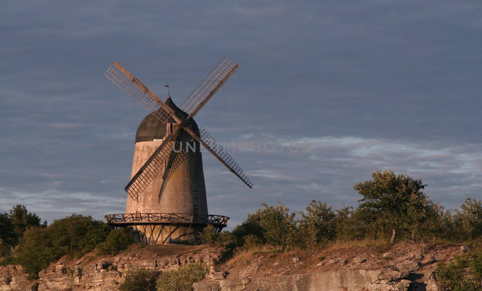 Old wind mill in beautiful lightning at dawn.