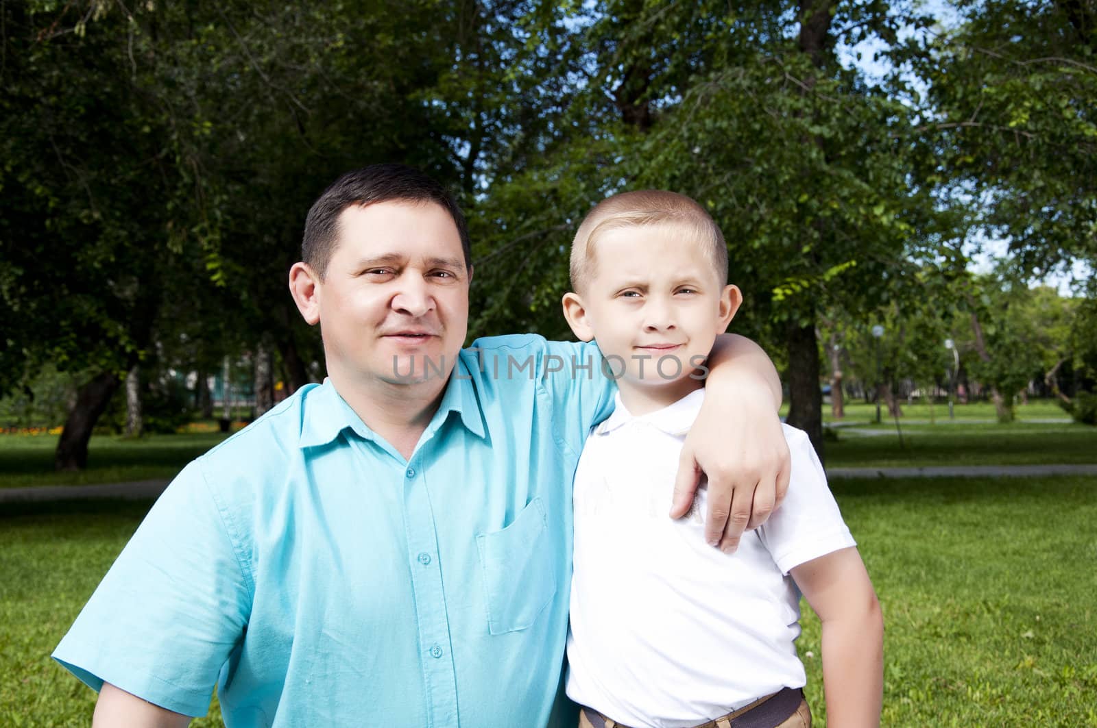 The portrait of the father and the son, stay in park together, are happy