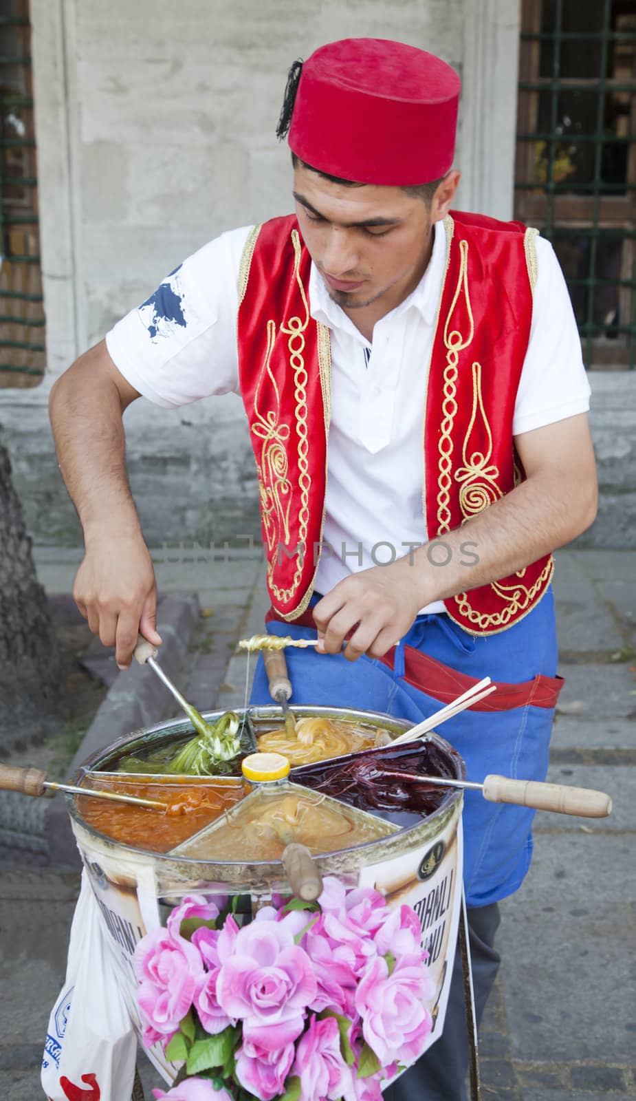June 2011 Turkish ice cream vendor in typical uniform outside Topkapi Palace, Istanbul Turkey. Portrait