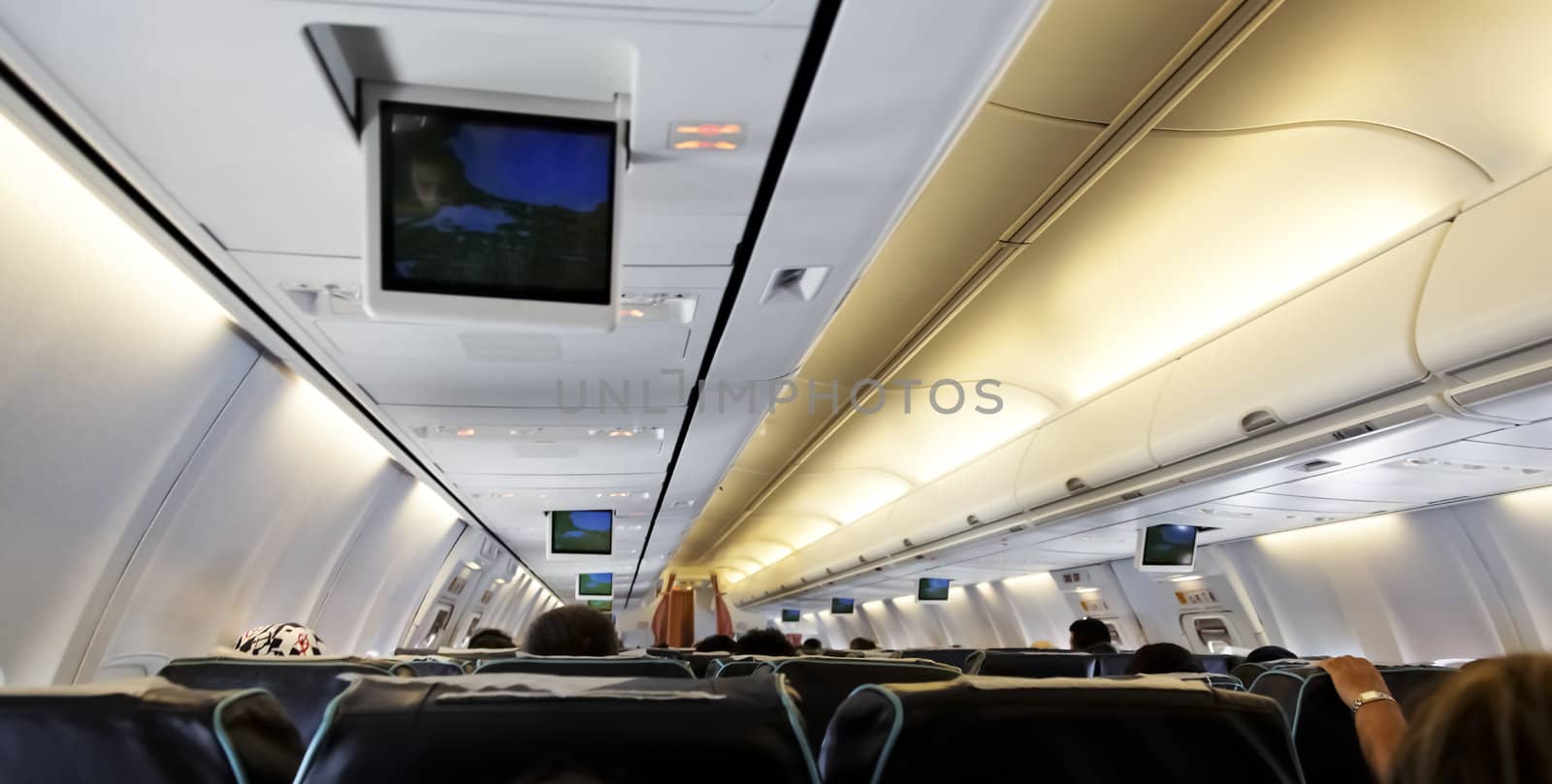 June 2011, inside of a passenger airline, backs of passengers, somewhere over Asia Indian Ocean