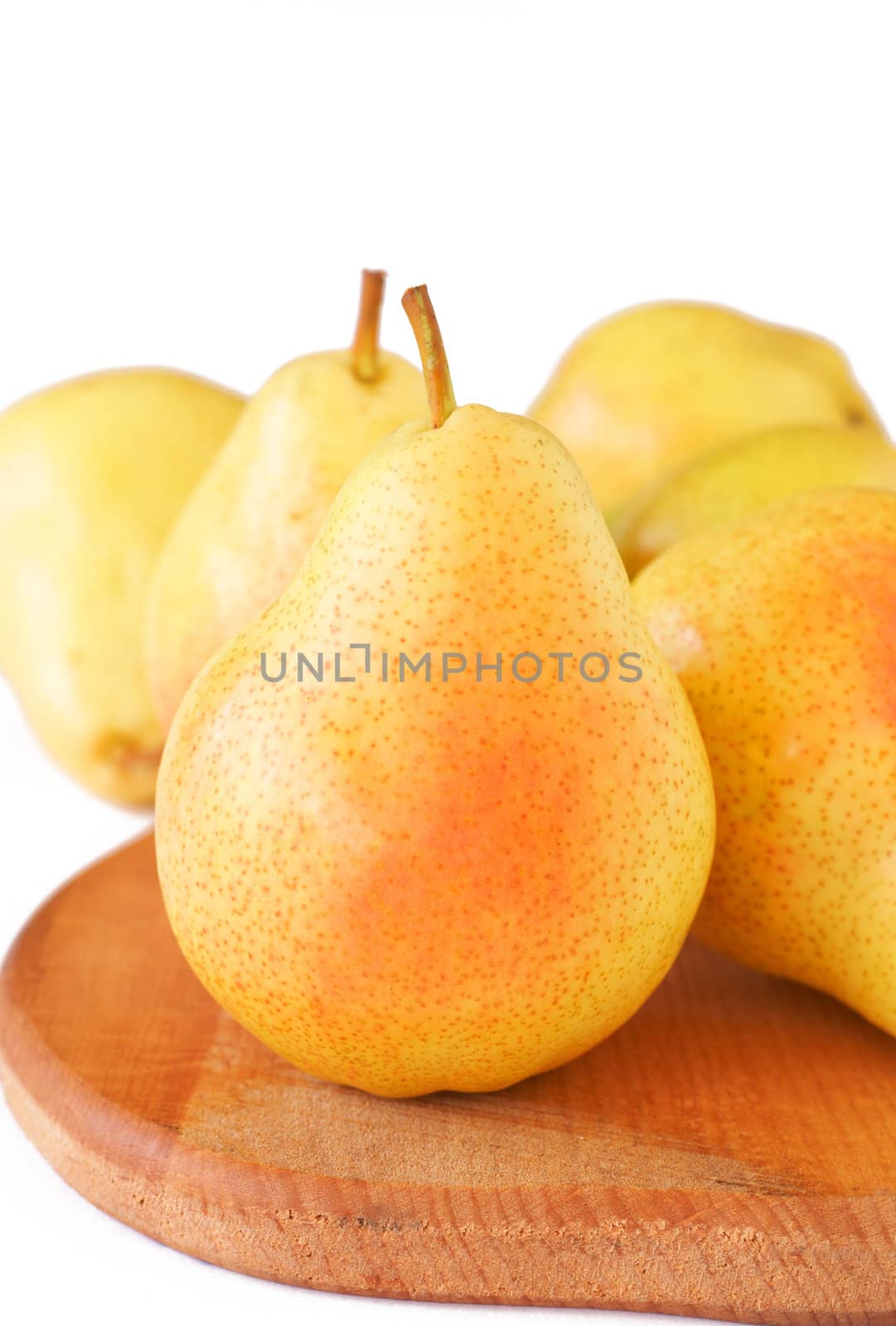 Bunch of ripe yellow pears on white background