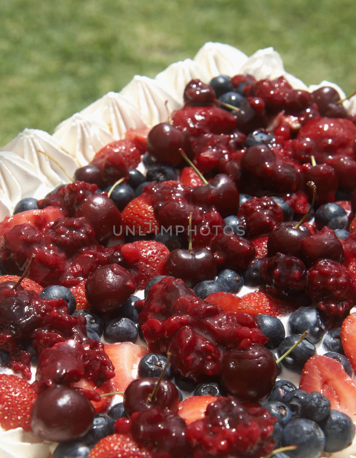 Meringue pavlova with cherries, strawberries and blueberries