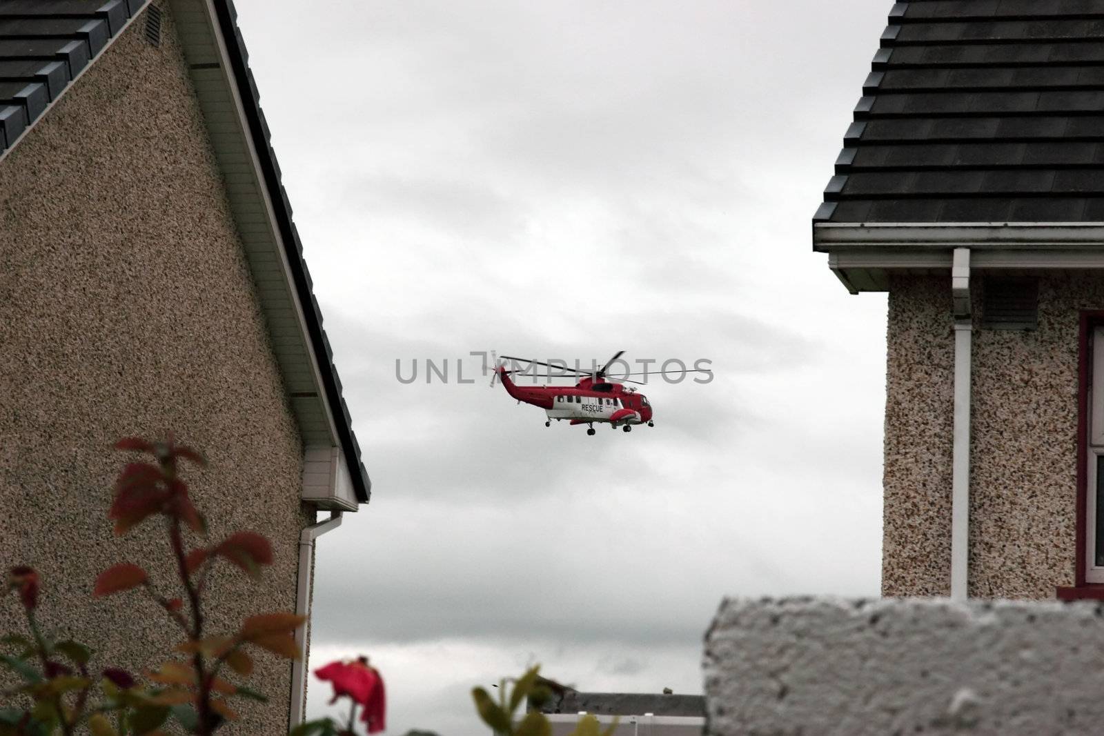 a helicopter on a life air sea rescue mission over an urban area in ireland