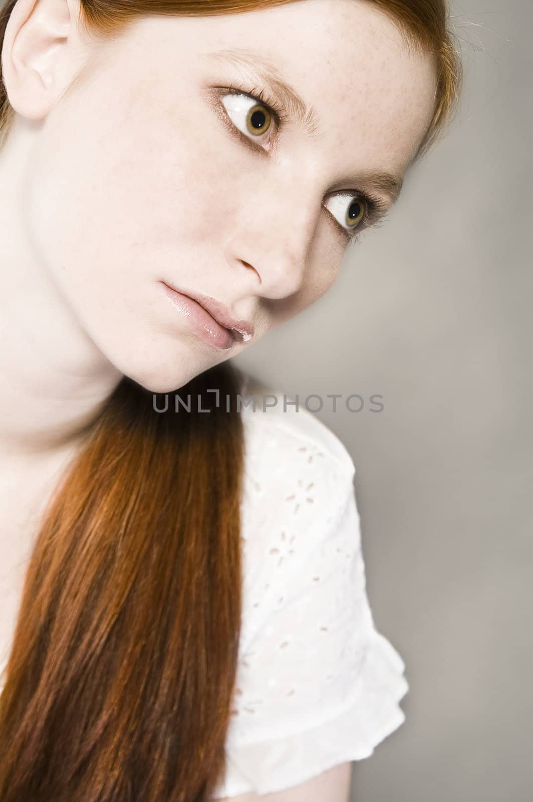 Studio portrait of a natural redhead with lipgloss