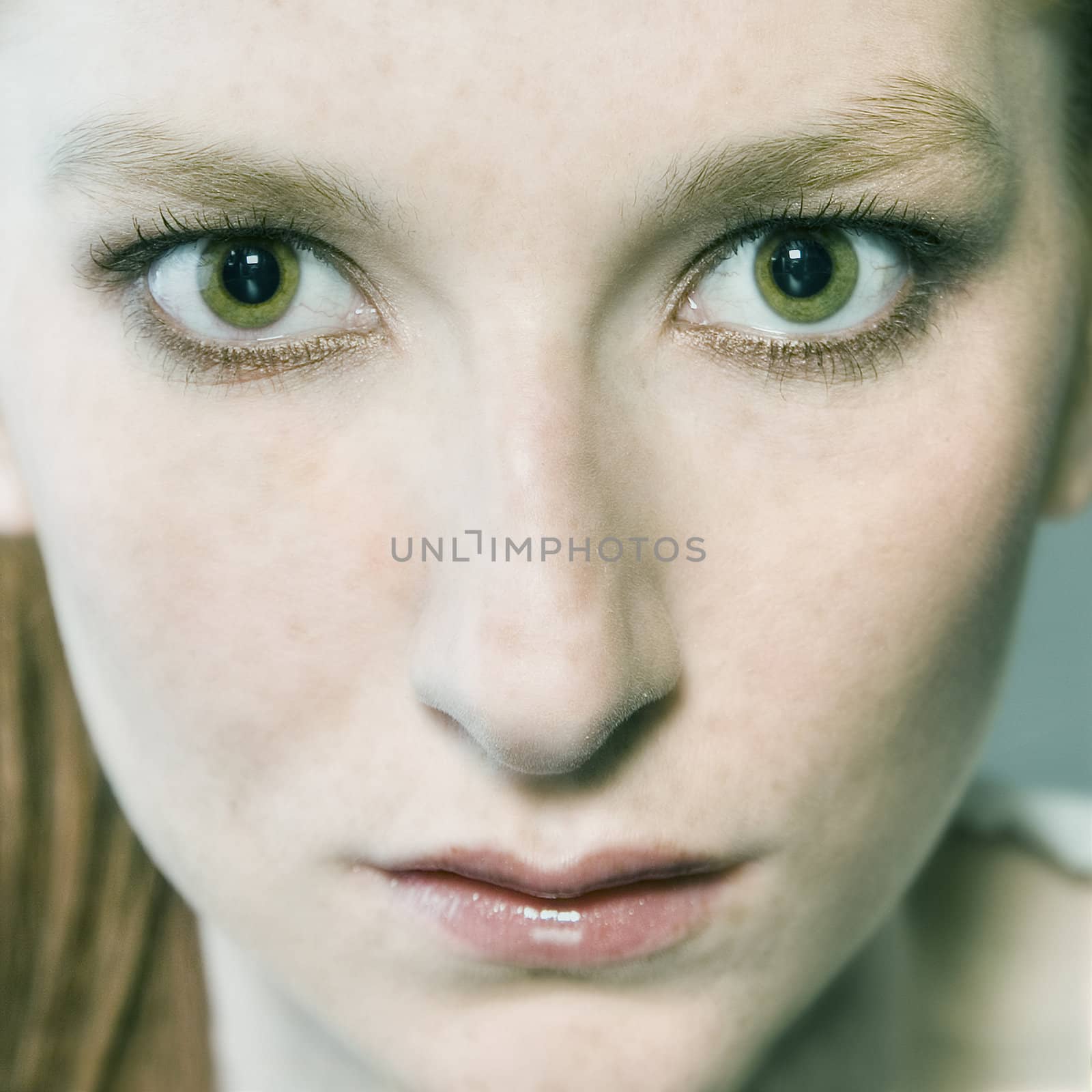 Studio portrait of a natural redhead with green eyes