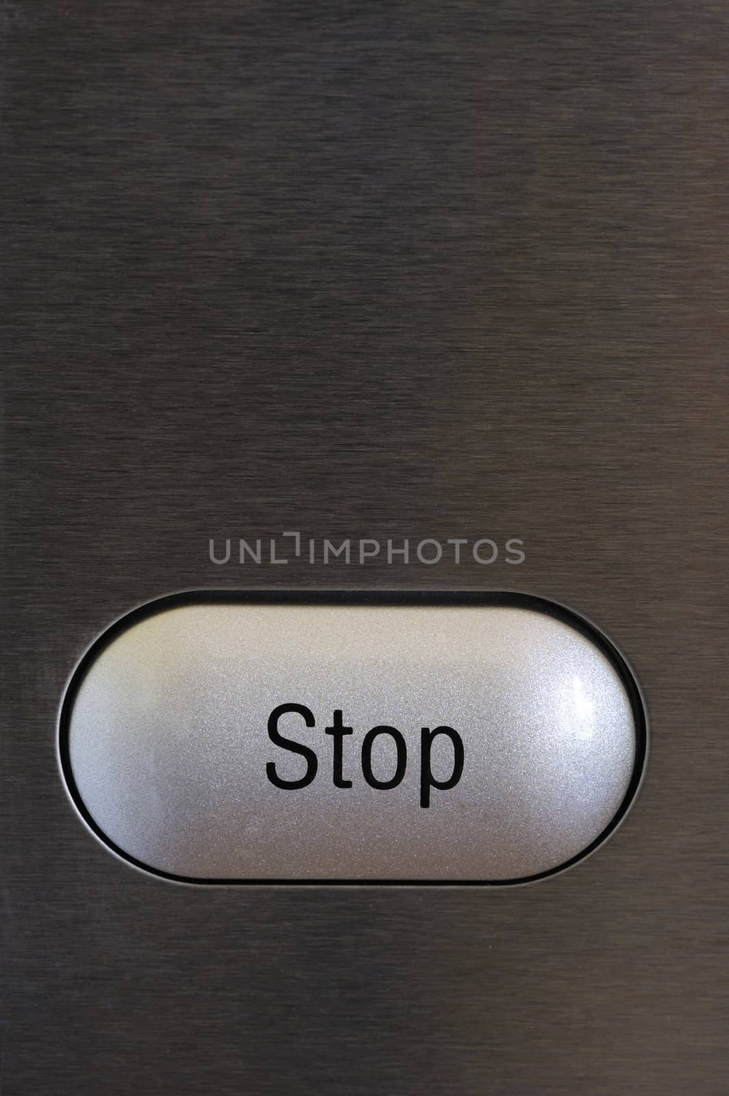 A stop button on a textured grey background. Space for text on the background.