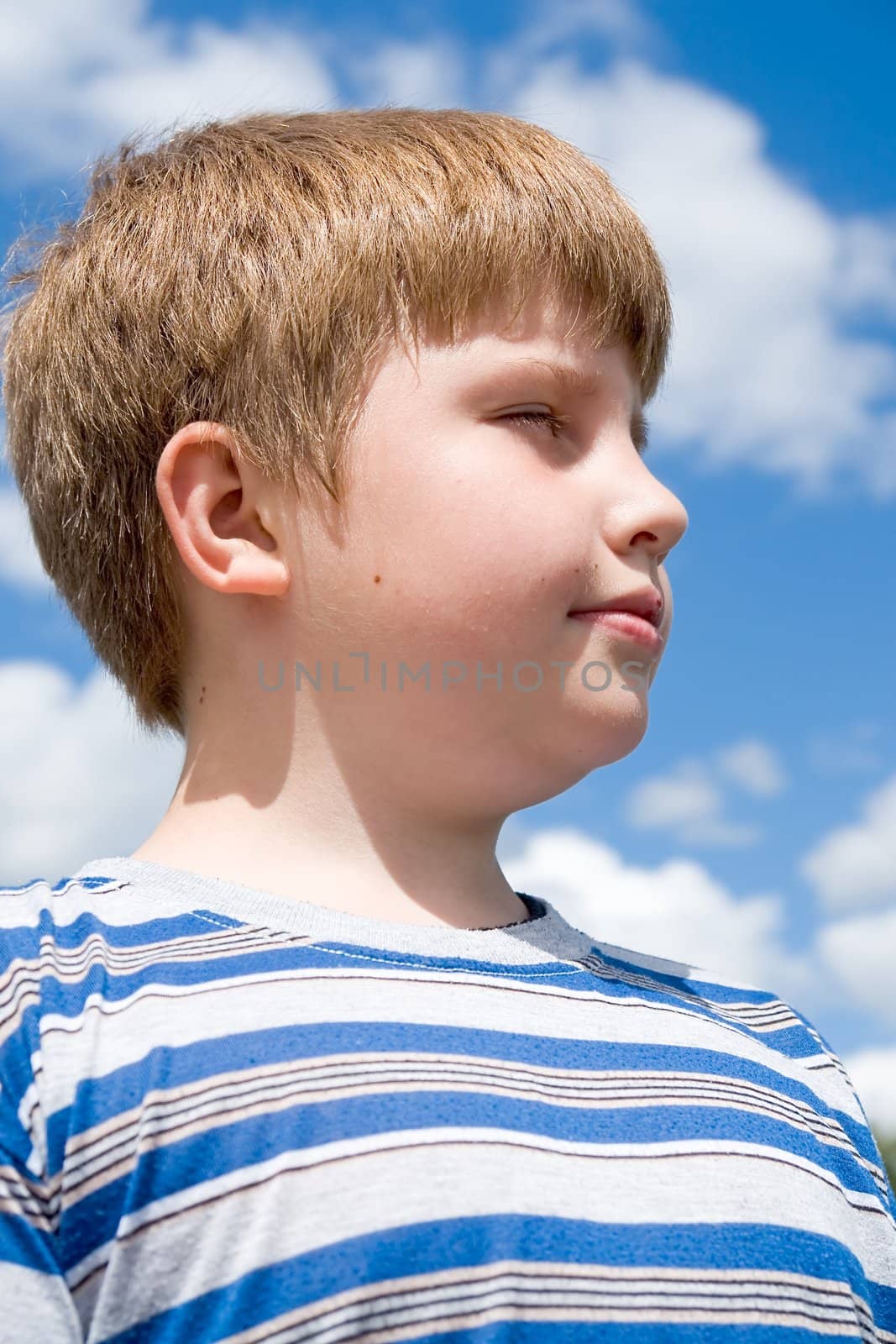 Boy. Half face with sky at background