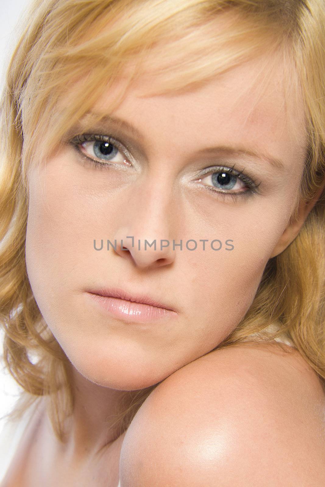 Studio portrait of a red haired model with reddish hair and blue eyes