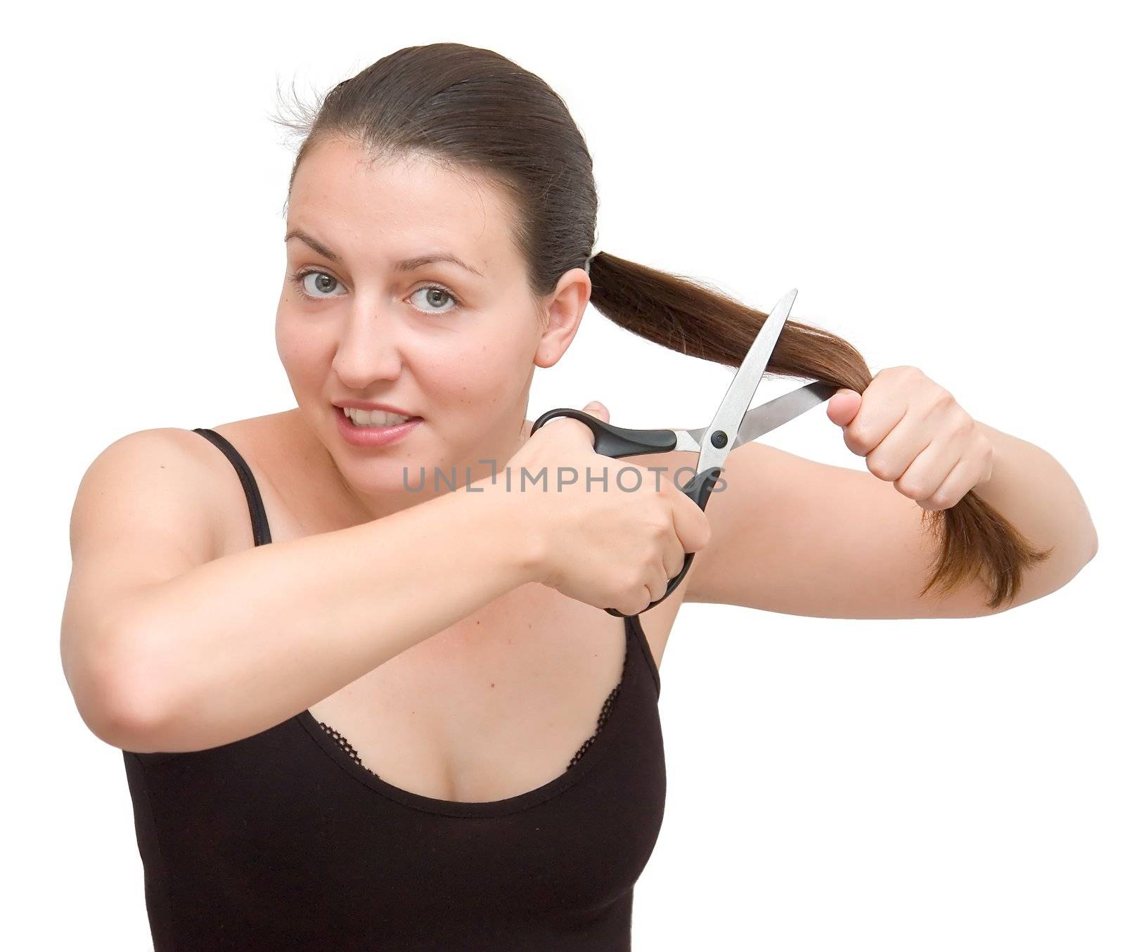 The young woman cuts off the hair on a white background