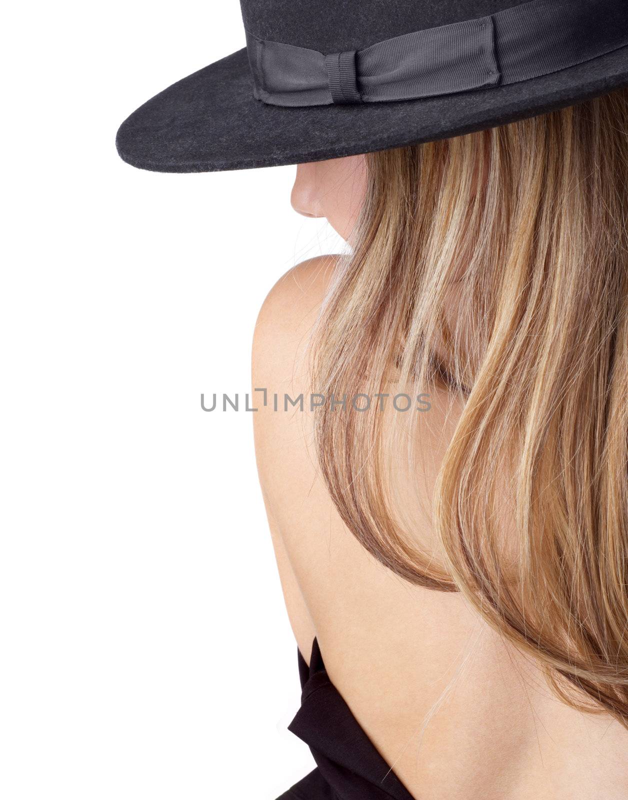 Backside view of topless and undressing blong girl in black felt hat.isolated on white. Copyspace.