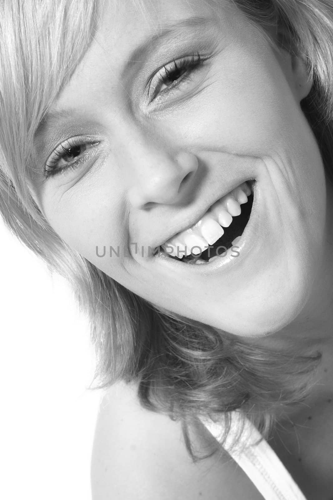 Studio portrait of a red haired model with a big toothy smile