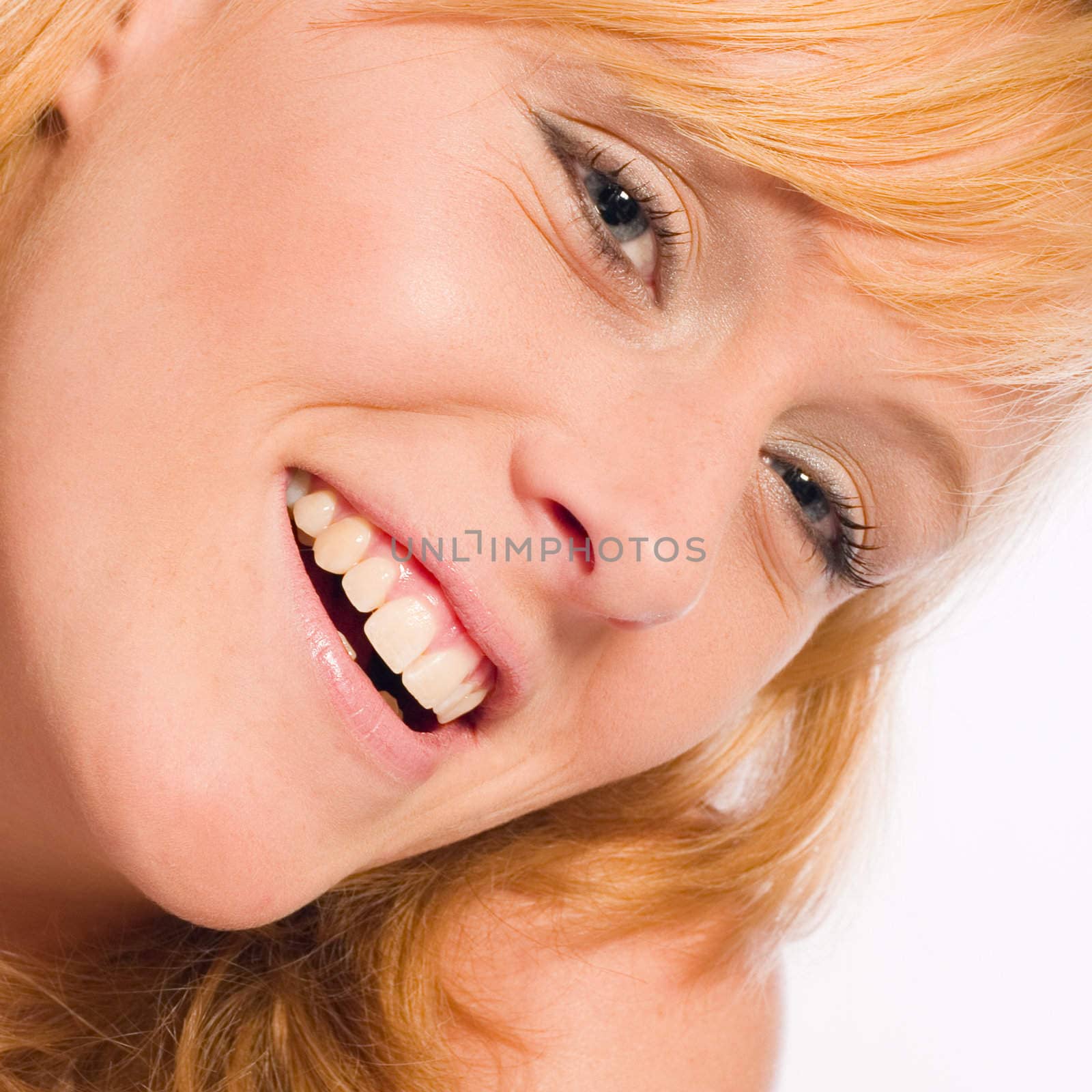 Studio portrait of a red haired model smiling