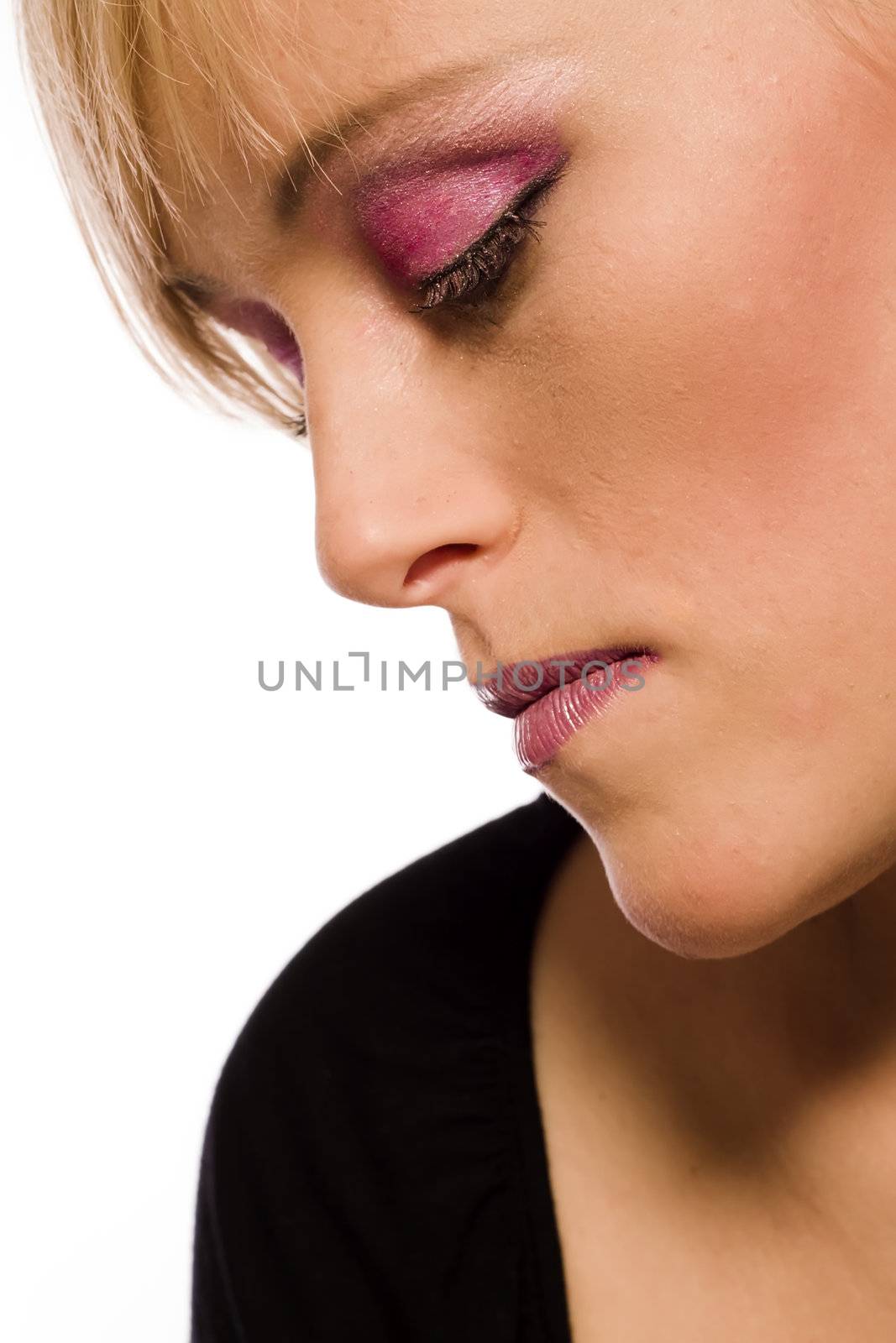 Studio portrait of a red haired model with strong make-up