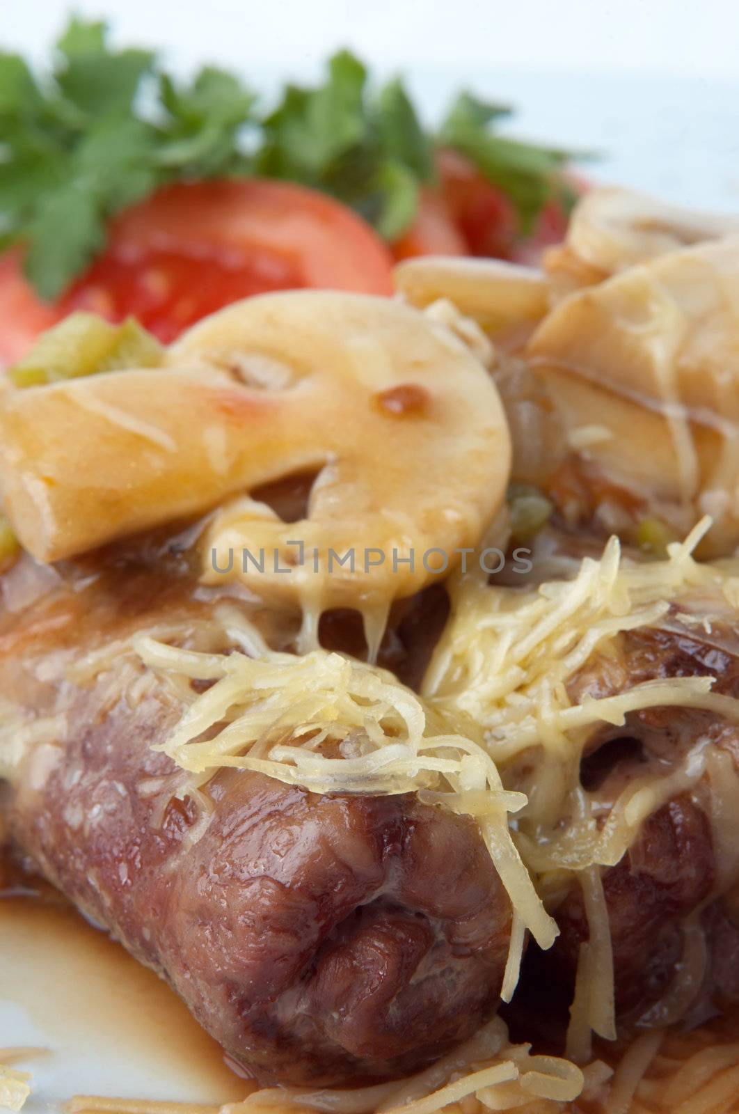 grilled meat rolls with mushrooms, melted cheese and vegetable garnish