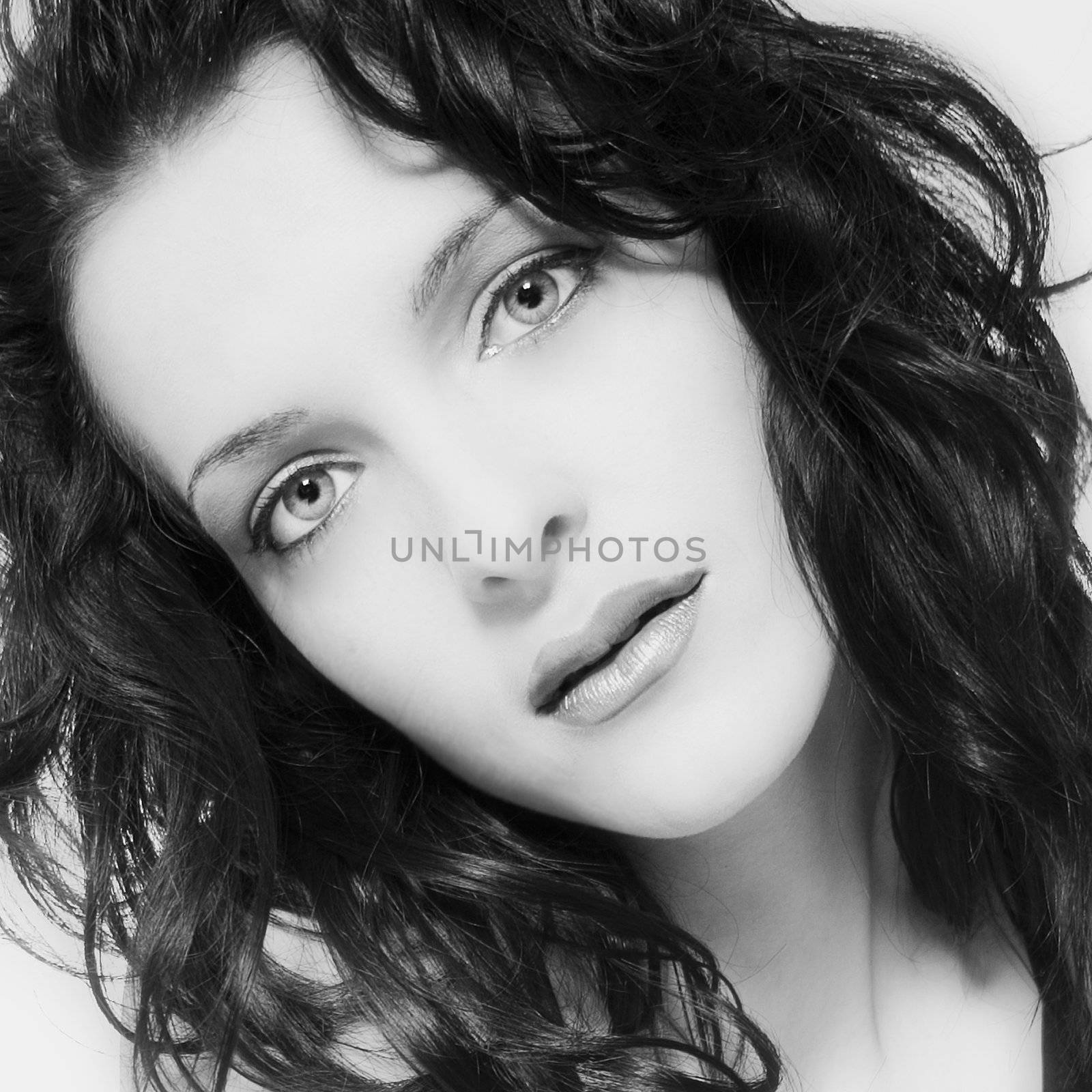 Studio portrait of a long haired beautifull woman looking surprised