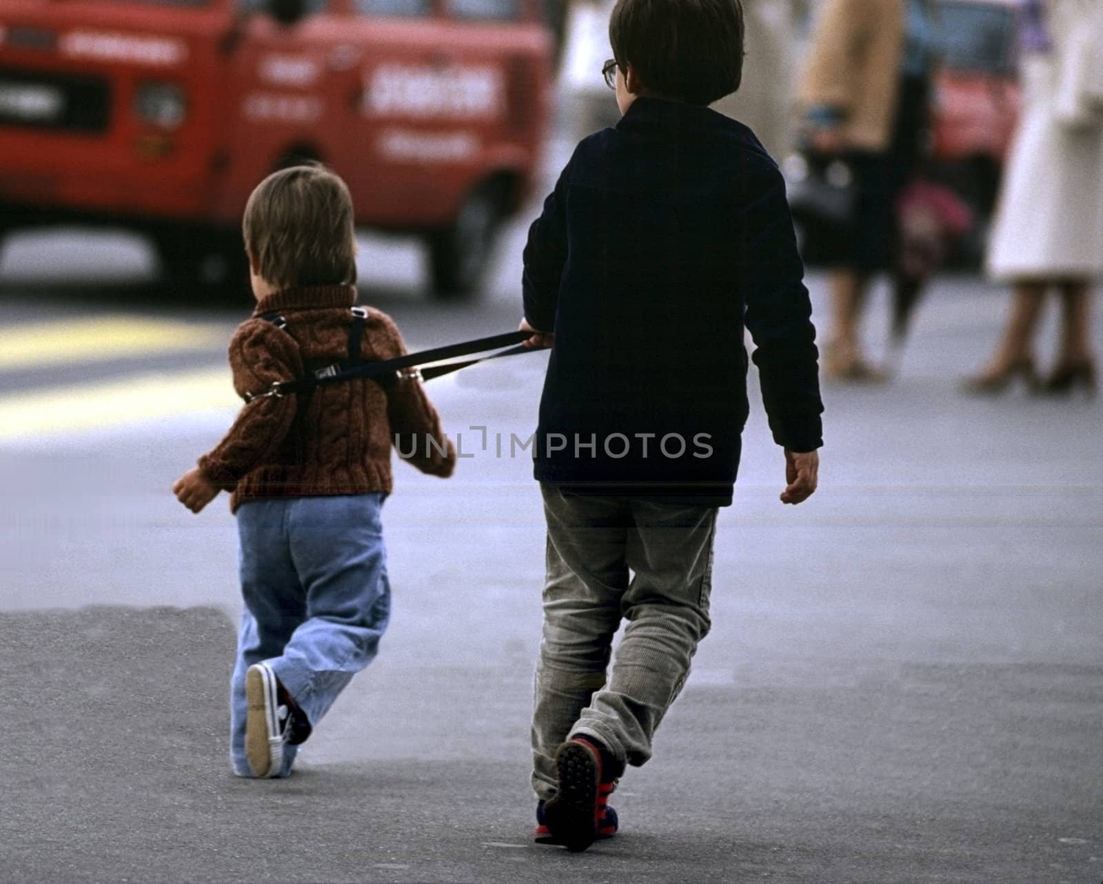 Older brother holding the younger one back