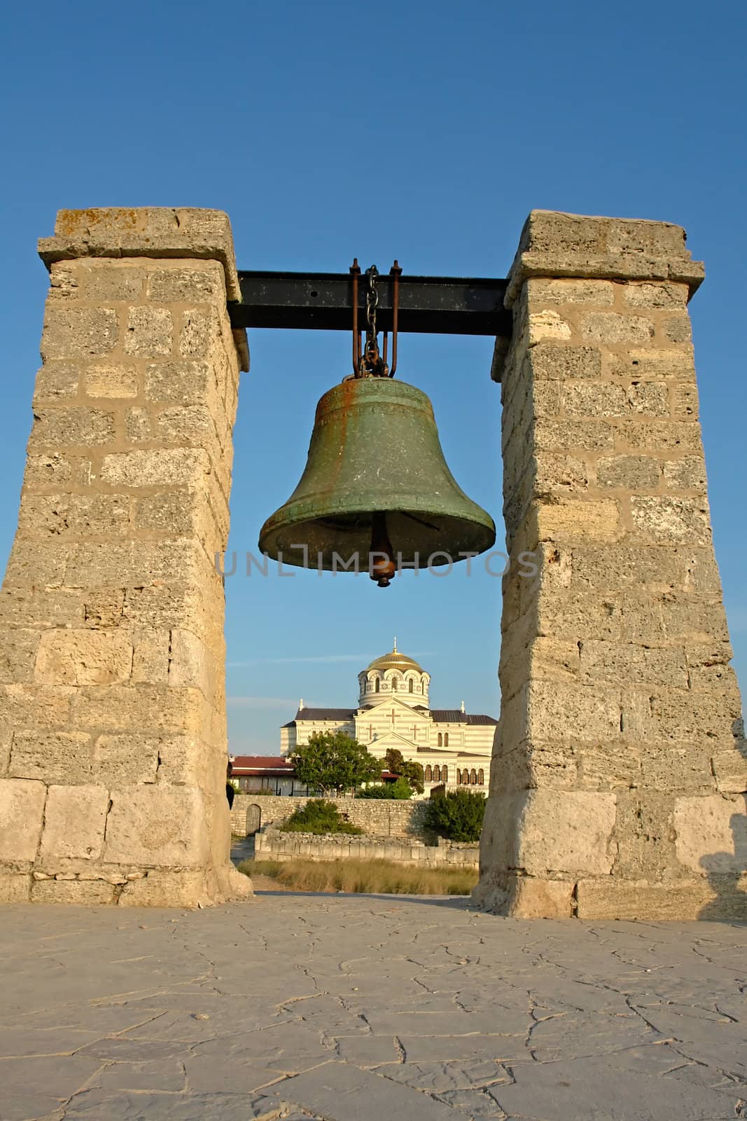 The big bell on a background of the Cathedral in Chersonese near Sevastopol                               