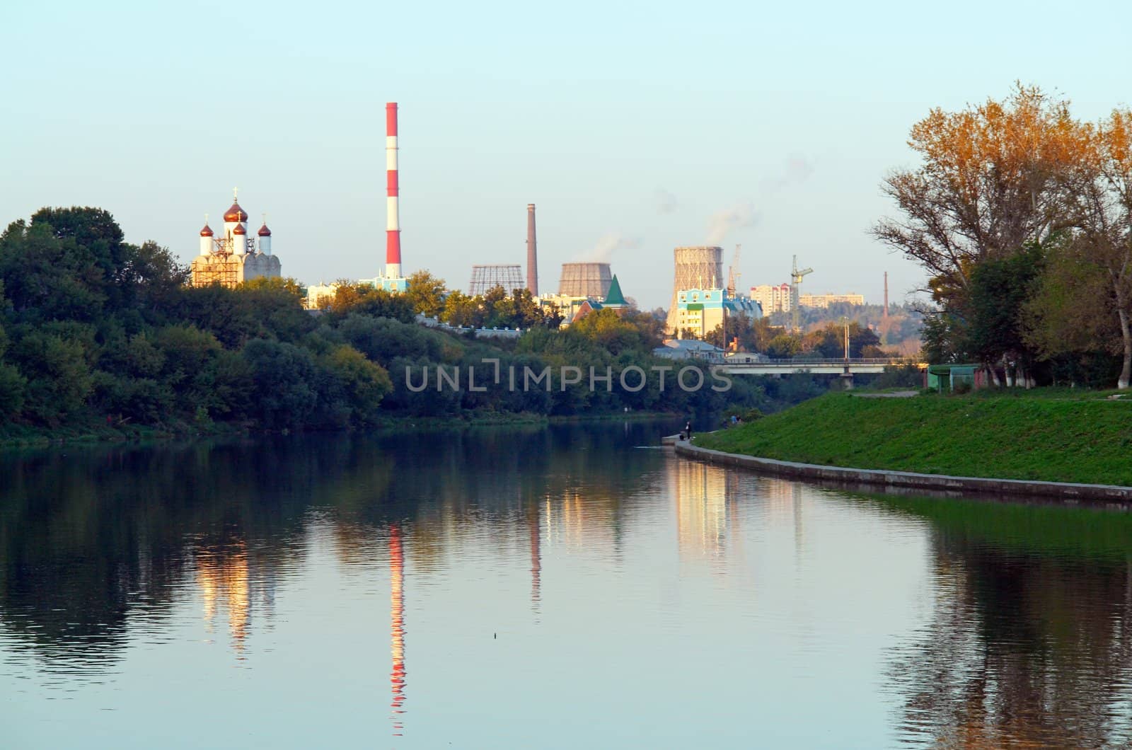 The power station is reflected in the river