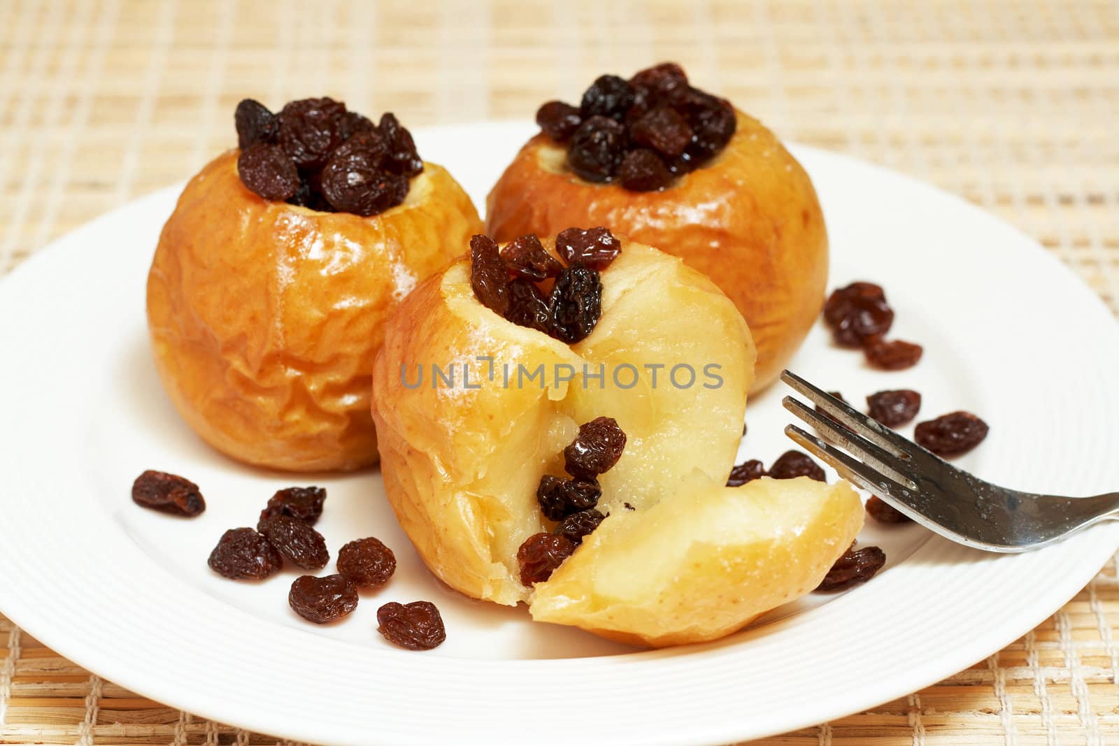 Delicious dessert of freshly baked organic apples with raisins